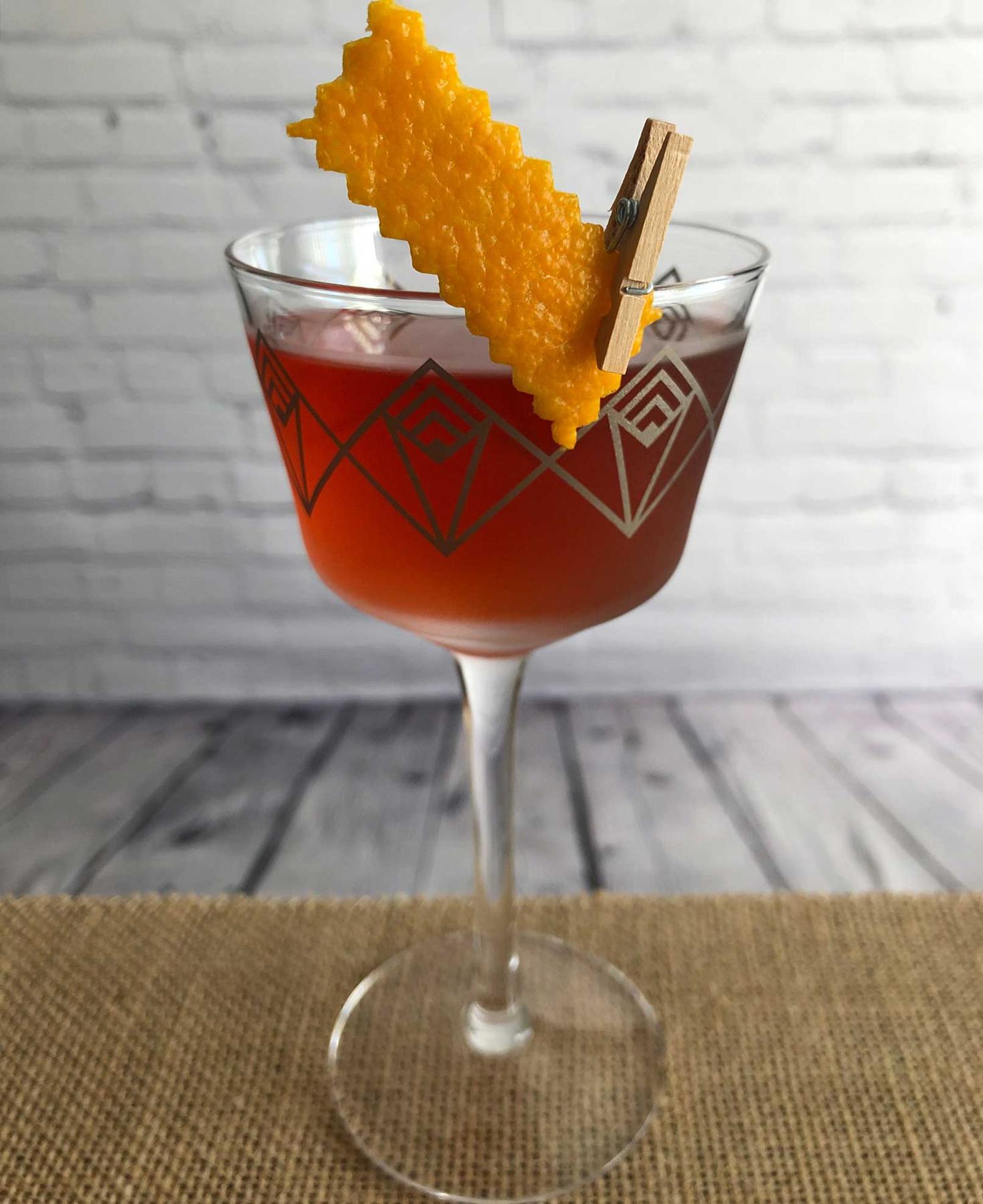An example of the Byrrh Martinez, the mixed drink (drink) featuring Hayman’s Old Tom Gin, Byrrh Grand Quinquina, maraschino liqueur, and orange twist; photo by Lee Edwards