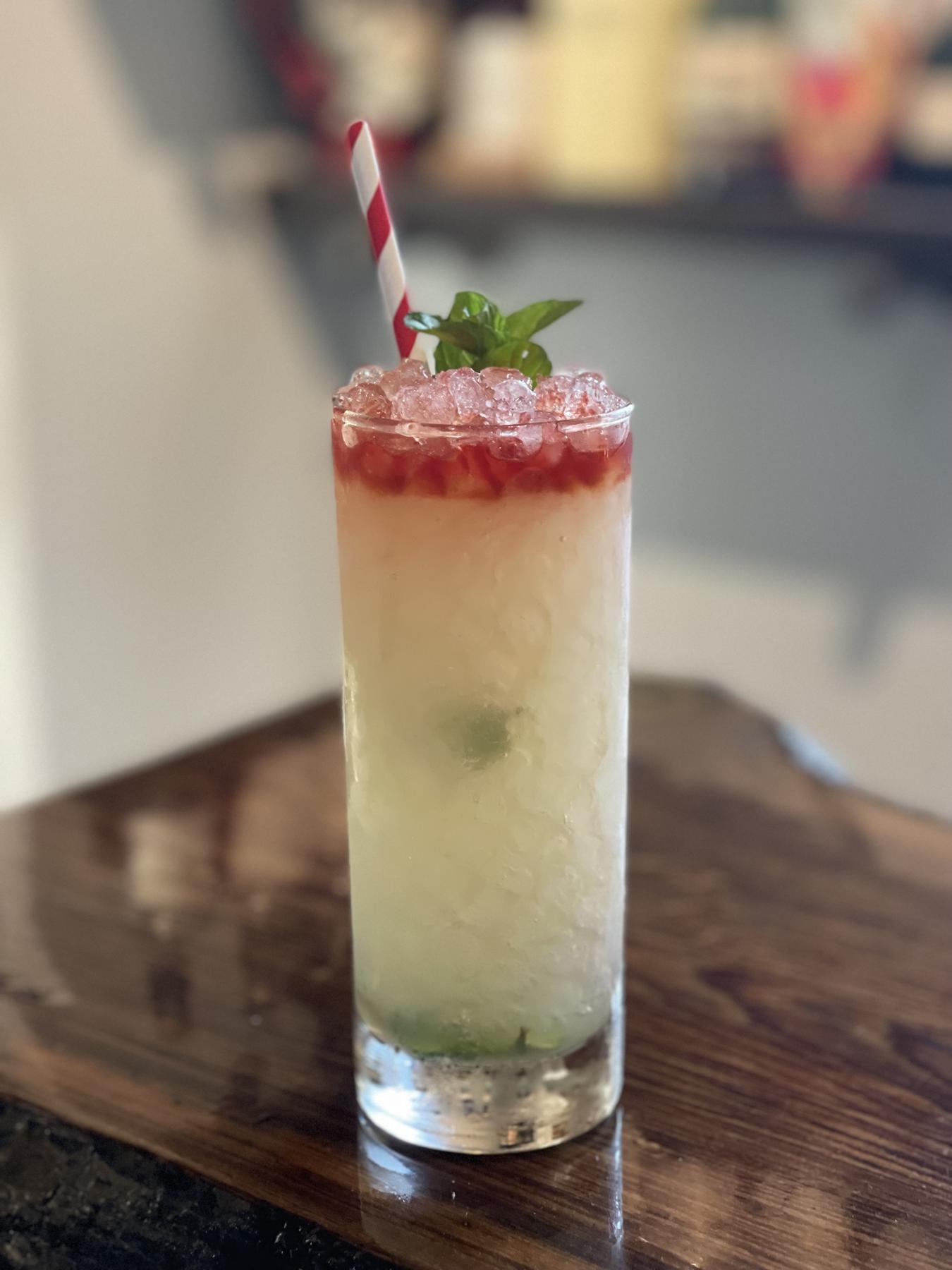 An example of the Queens Park Swizzle, the mixed drink (drink) featuring The Scarlet Ibis Trinidad Rum, lime juice, rich demerara syrup, Angostura bitters, mint leaves, and sprig of mint; photo by Zack McLeod