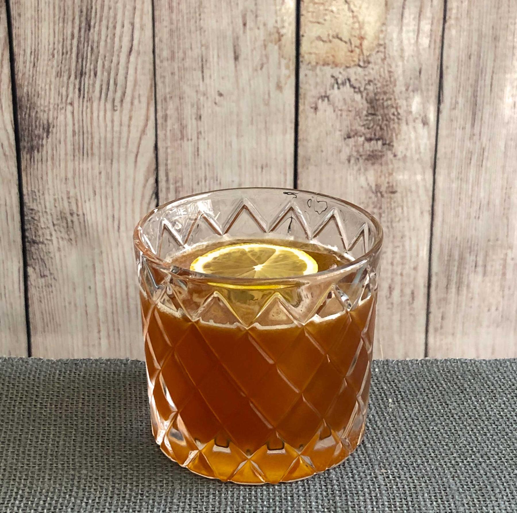 An example of the Campfire Sour, the mixed drink (drink) featuring Amaro Sfumato Rabarbaro, bourbon whiskey, lemon juice, and lemon wheel; photo by Lee Edwards