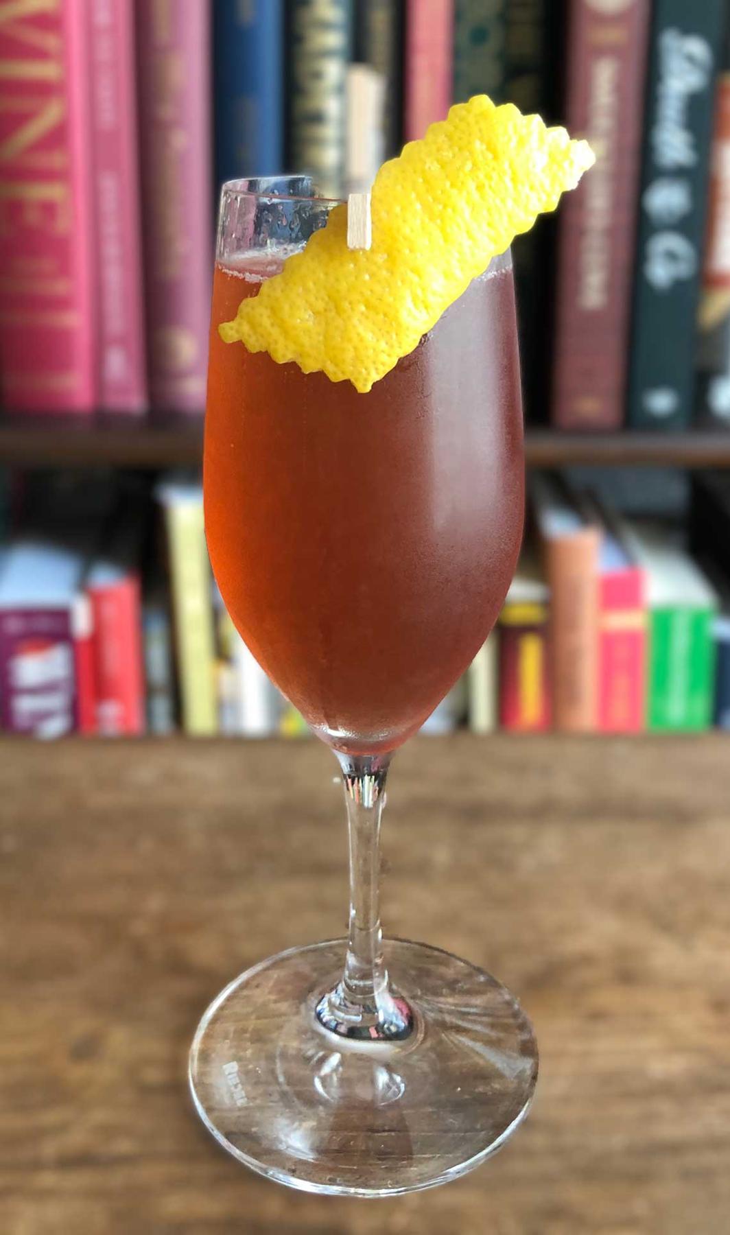 An example of the Damson Royale, the mixed drink (drink) featuring sparkling wine, Averell Damson Plum Gin Liqueur, lemon juice, and lemon twist; photo by Lee Edwards