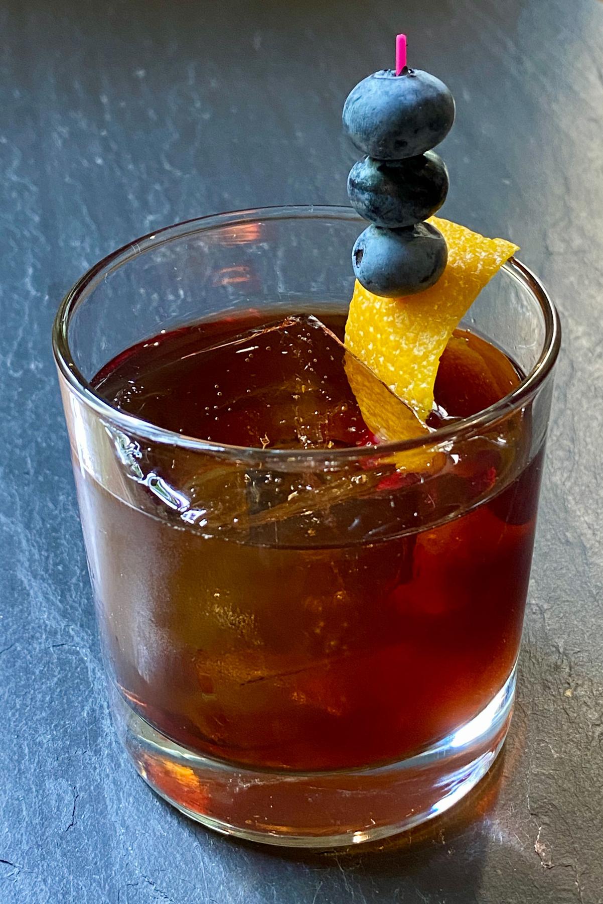 An example of the My One and Only Blue, the mixed drink (drink) featuring bourbon whiskey, Pasubio Vino Amaro, and orange twist; photo by Martin Doudoroff