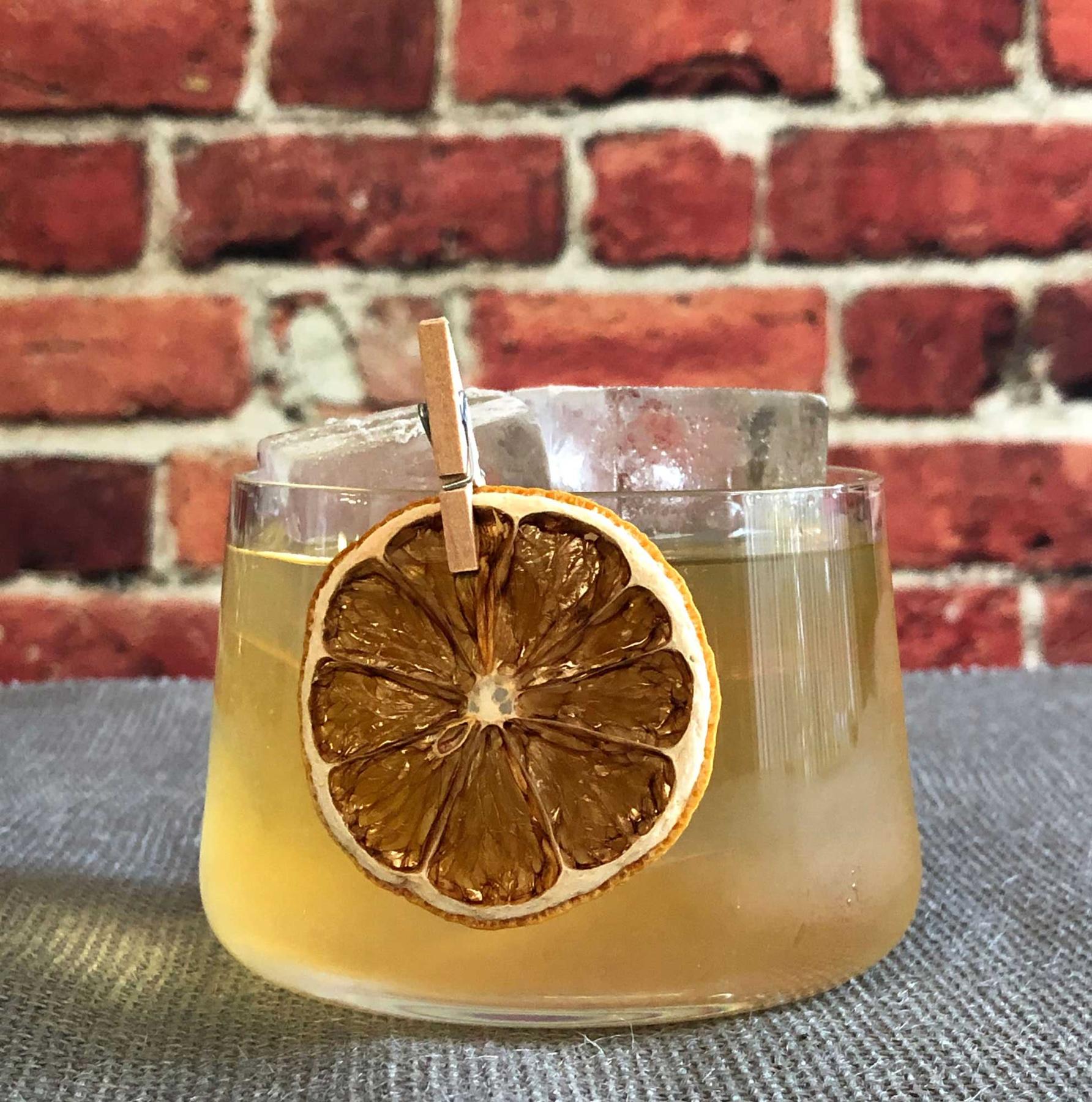 An example of the July on Royal Street, the mixed drink (drink) featuring Mattei Cap Corse Blanc Quinquina, Salers Gentian Apéritif, reposado tequila, Bénédictine, and lemon juice; photo by Lee Edwards
