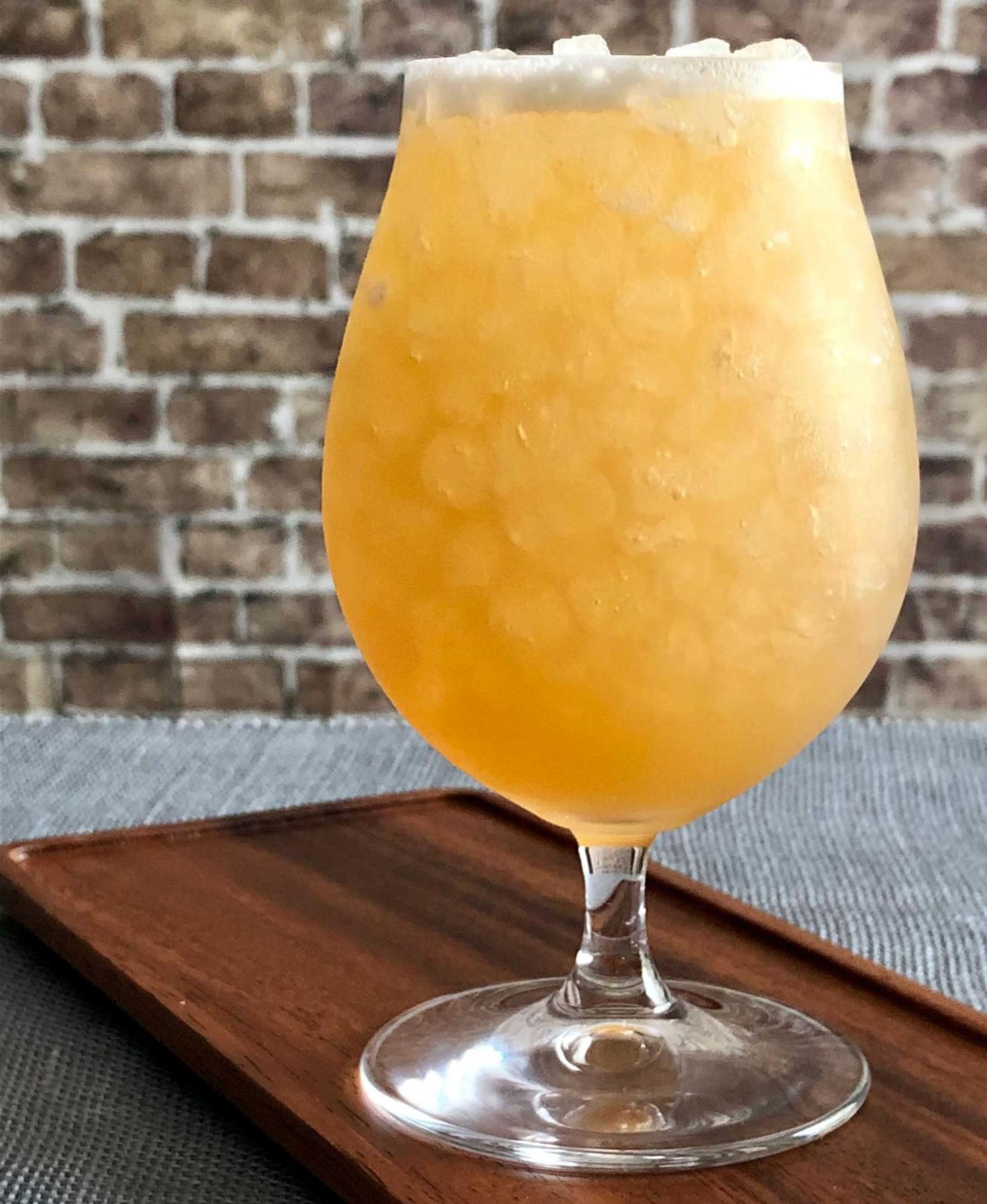 An example of the Sawbuck, the mixed drink (drink), by Kirkland Tap & Trotter, Cambridge, MA, featuring india pale ale, rye whiskey, cinnamon-infused sugar syrup, lemon juice, Nux Alpina Walnut Liqueur, and lump of cracked ice; photo by Lee Edwards