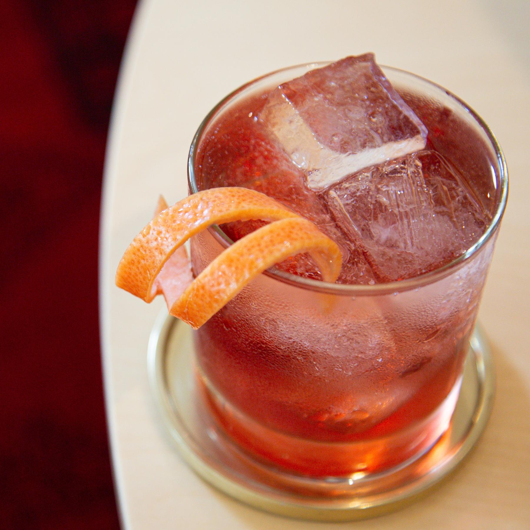 An example of the Rosa Classico, the mixed drink (drink) featuring Cocchi Americano Rosa, soda water, and grapefruit twist; photo by Megan Heinowski