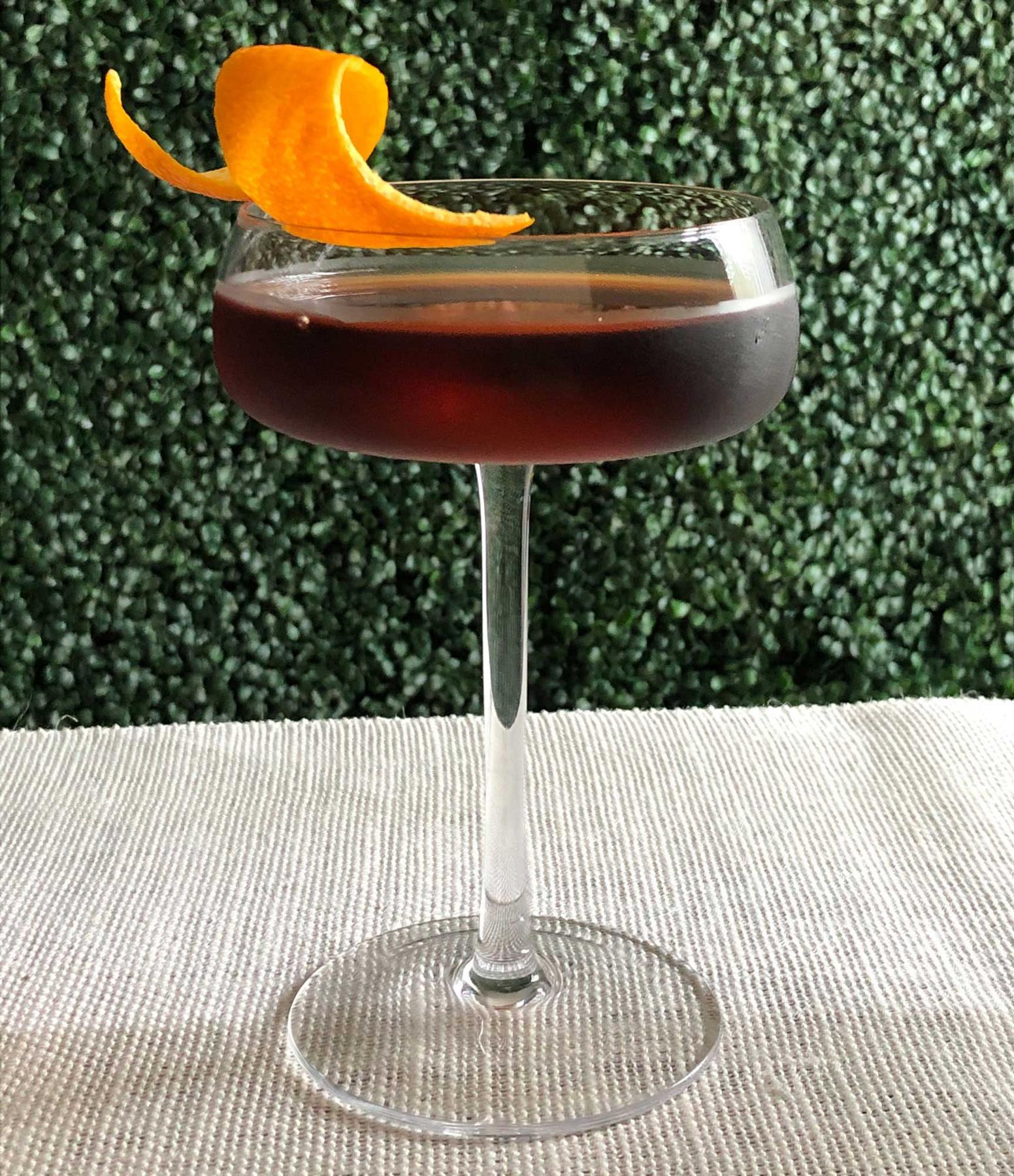 An example of the In Vida Veritas, the mixed drink (drink), by Misty Kalkofen, Boston, MA, featuring Del Maguey Mezcal Vida, Zirbenz Stone Pine Liqueur of the Alps, Nux Alpina Walnut Liqueur, Bénédictine, chocolate bitters, and orange twist; photo by Lee Edwards