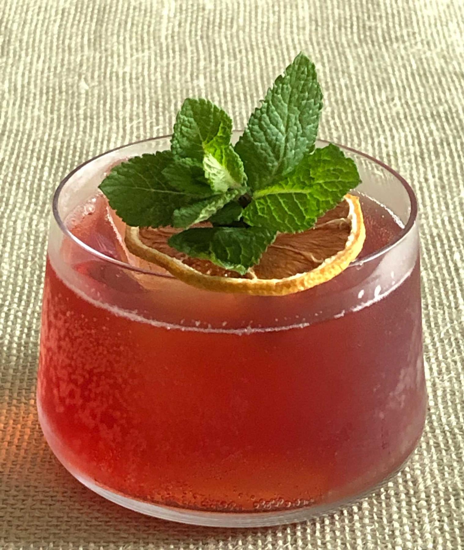 An example of the Byrrh & Tonic, the mixed drink (drink) featuring Byrrh Grand Quinquina, tonic water, sprig of mint, and lemon twist; photo by Lee Edwards
