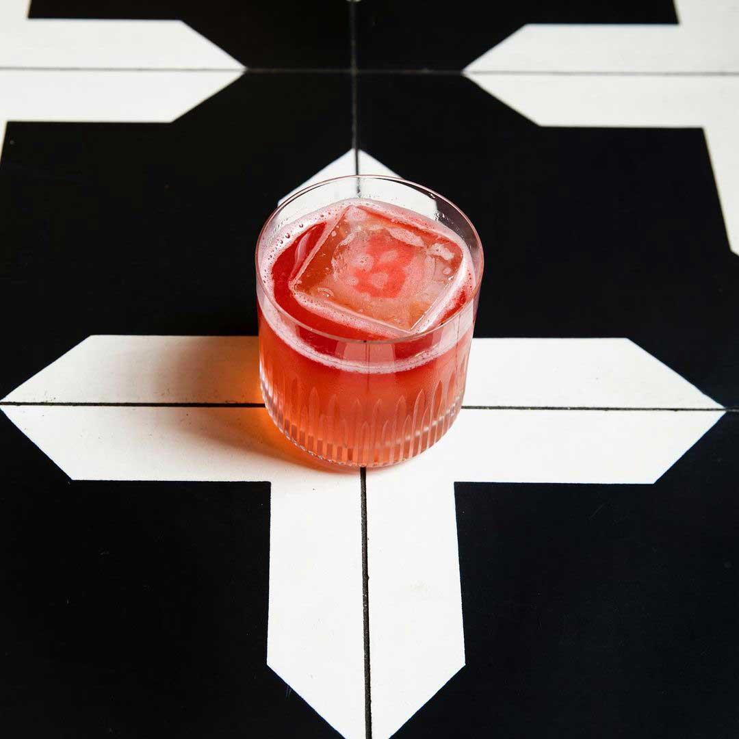 An example of the Ply & Pin, the mixed drink (drink), by Nick Talarico, AM Hospitality, Memphis TN, featuring bourbon whiskey, John D. Taylor’s Velvet Falernum, cranberry juice, rye whiskey, lime juice, and Peychaud’s Aromatic Cocktail Bitters; photo by Julie Soefer