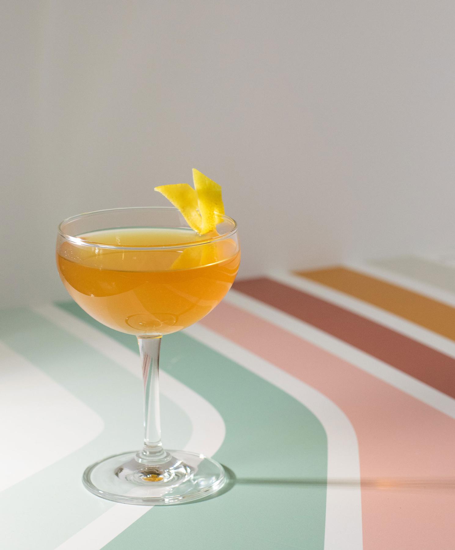 An example of the Algonquin, the mixed drink (drink) featuring rye whiskey, Cocchi Vermouth di Torino Extra Dry, pineapple syrup, orange bitters, and lemon twist; photo by Boon and Caro Sheridan