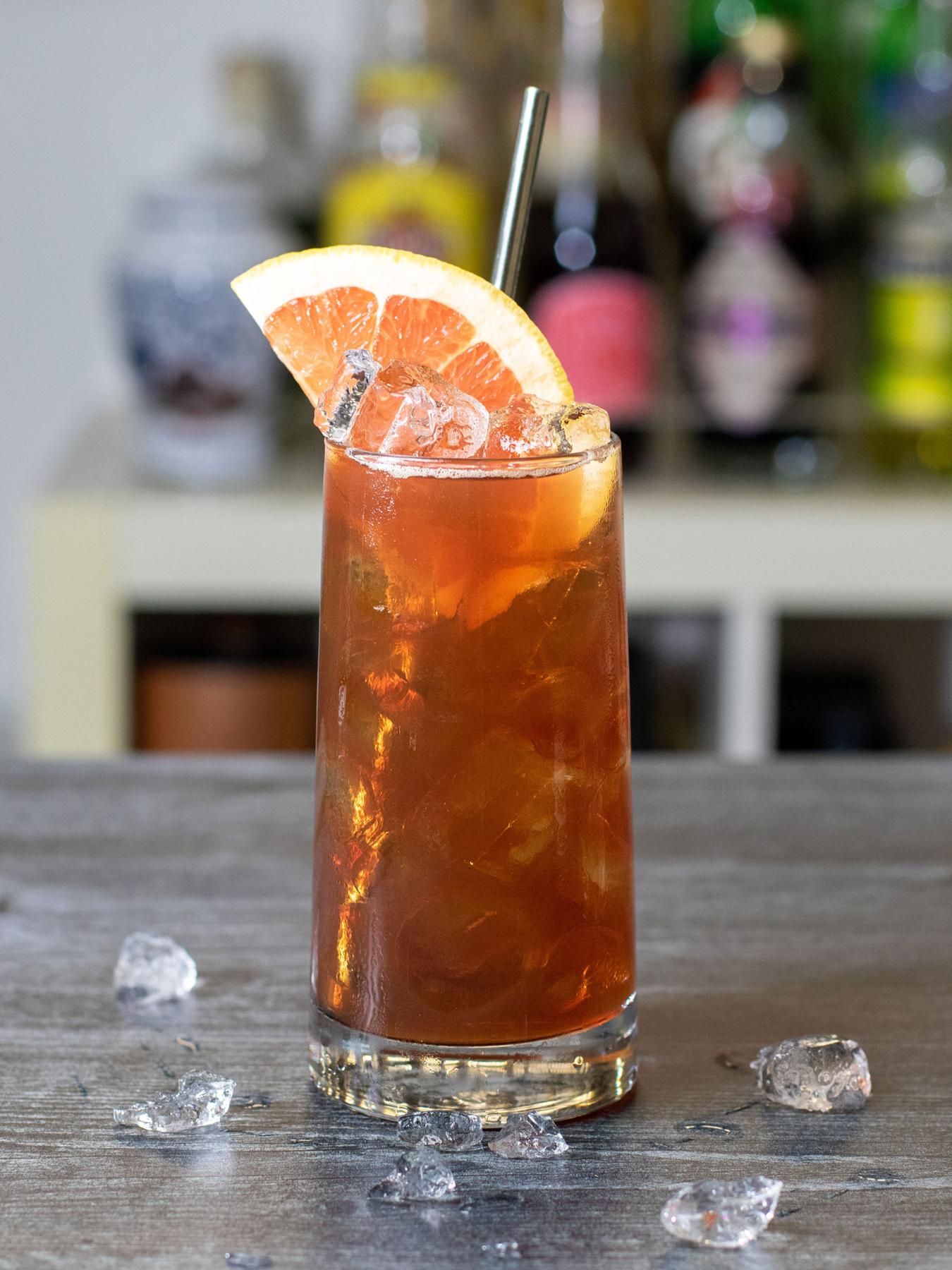 An example of the Arrowhead Limited, the mixed drink (drink), adapted from a drink by Damon Boelte, Grand Army Bar, NYC, featuring india pale ale, Timbal Vermut de Reus Sweet Red, Aperitivo Mazzura, mezcal, and grapefruit wedge; photo by Boon and Caro Sheridan