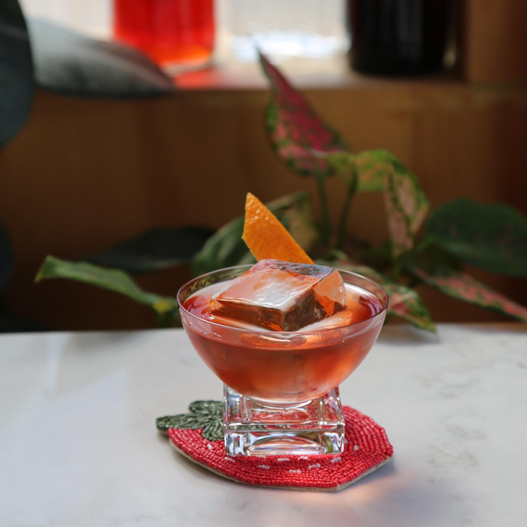 An example of the Wild Strawberry Negroni, the mixed drink (drink) featuring Hayman’s London Dry Gin, Aperitivo Mazzura, Chamberyzette, and orange twist; photo by Megan Heinowski