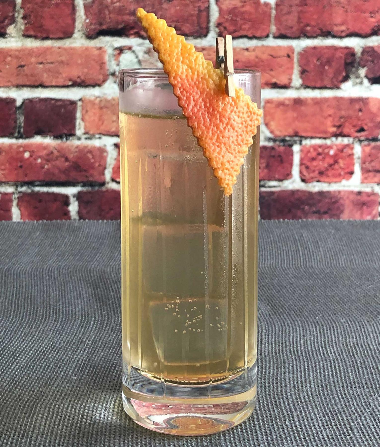 An example of the Kina Préparé, the mixed drink (drink) featuring soda water, Mattei Cap Corse Blanc Quinquina, Amaro Alta Verde, soda water, and grapefruit twist; photo by Lee Edwards