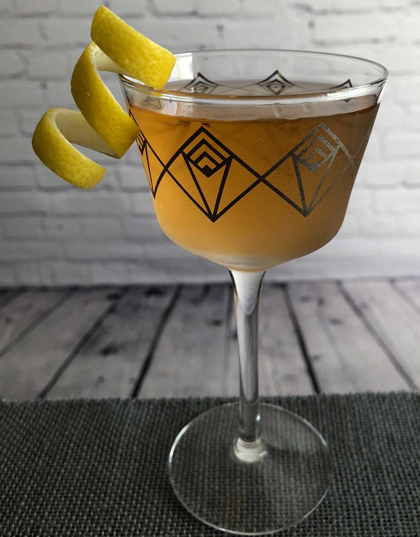 An example of the Prince Henry’s Reed, the mixed drink (drink) featuring Henriques & Henriques Rainwater Madeira, Dolin Dry Vermouth de Chambéry, orange bitters, and lemon twist; photo by Lee Edwards