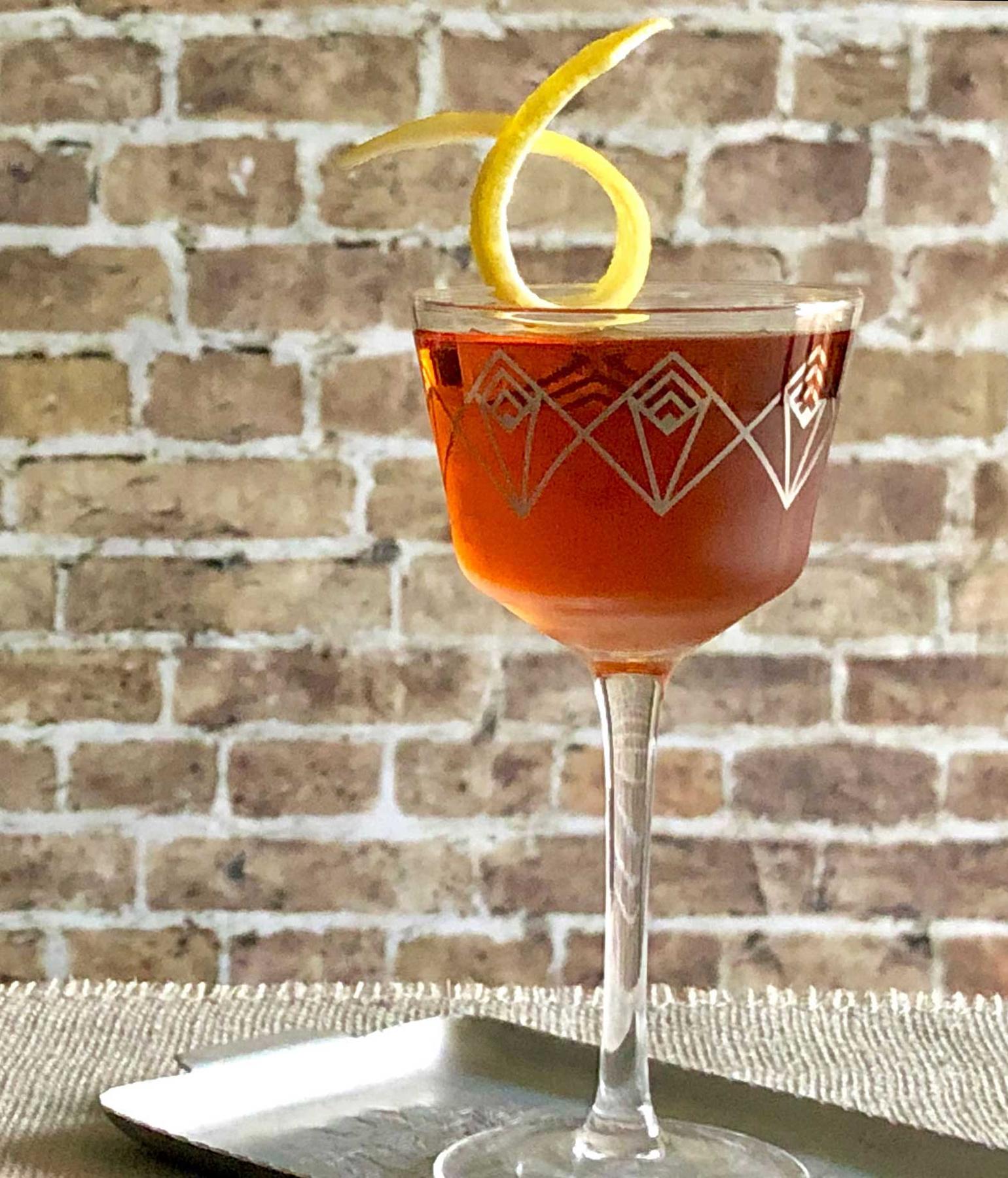 An example of the Southampton, the mixed drink (drink), variation of a drink from David Embury, The Fine Art of Mixing Drinks, featuring cognac, Rothman & Winter Orchard Cherry Liqueur, Angostura bitters, and lemon twist; photo by Lee Edwards