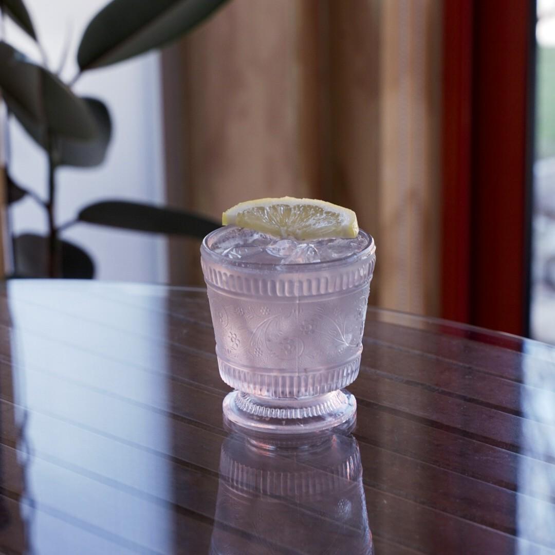 An example of the Scotch Violets, the mixed drink (drink), by Carey Jones and John D. McCarthy, Food & Wine, 2015, featuring blended scotch whisky, lemon juice, Rothman & Winter Crème de Violette, honey syrup, and lemon wheel; photo by Madison Young