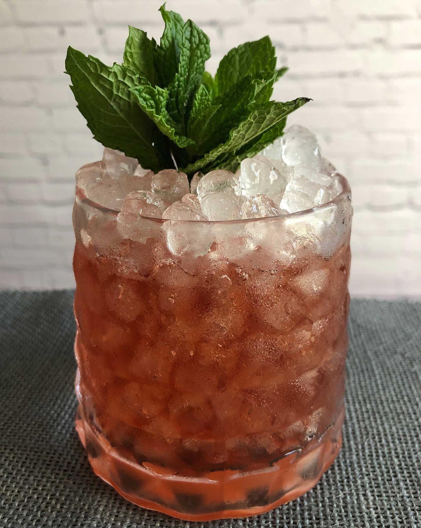 An example of the Berbyrrh, the mixed drink (drink) featuring Byrrh Grand Quinquina, verbena tisane, sprig of mint, and lemon twist; photo by Lee Edwards