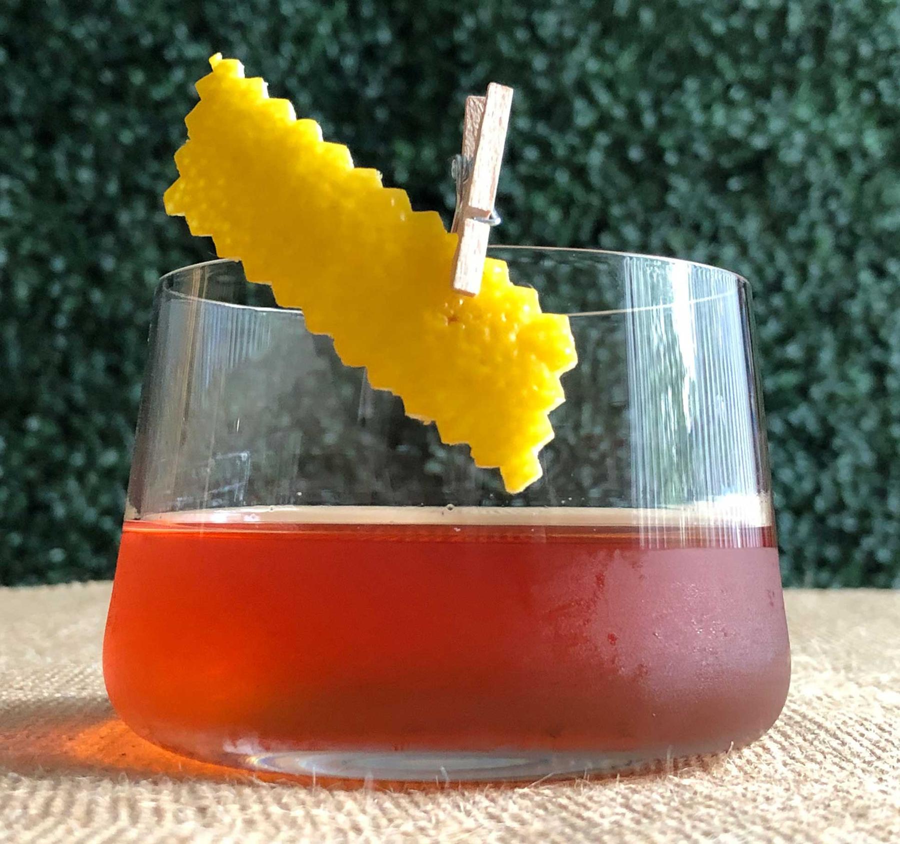 An example of the Stone Pine Sazerac, the mixed drink (drink) featuring rye whiskey, Zirbenz Stone Pine Liqueur of the Alps, rich simple syrup, Zirbenz Stone Pine Liqueur of the Alps, and lemon twist; photo by Lee Edwards
