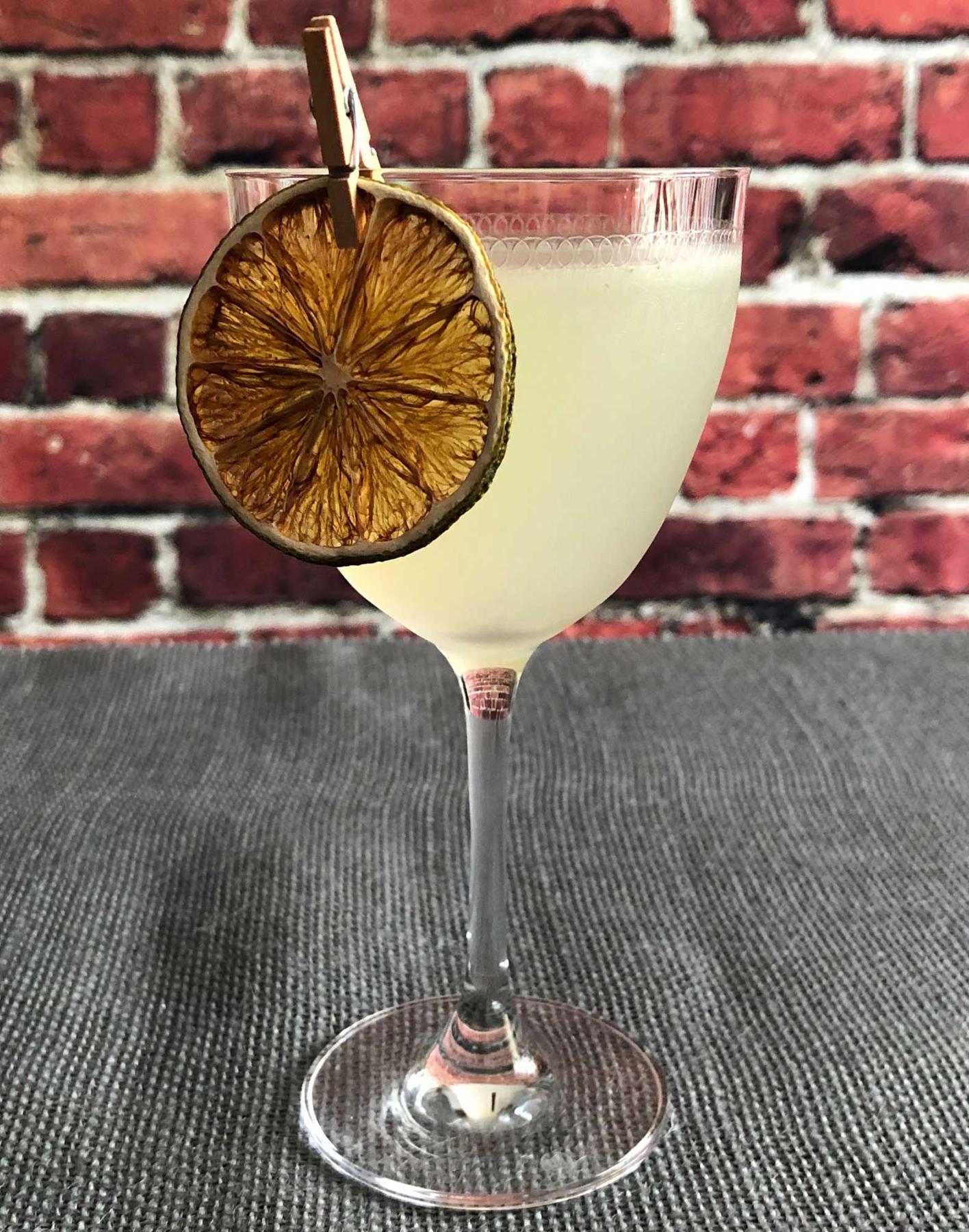 An example of the Dutch East Indies Daisy, the mixed drink (drink), by Erik Lorincz, The Connaught Bar, featuring Batavia Arrack van Oosten, lime juice, crème de cacao (white), simple syrup, chocolate, and fennel; photo by Lee Edwards