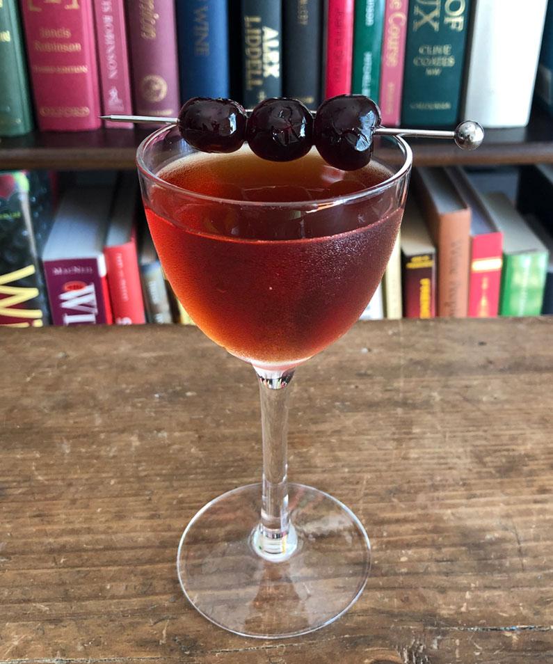 An example of the Rob Roy, the mixed drink (drink) featuring blended scotch whisky, Cocchi Dopo Teatro Vermouth Amaro, Angostura bitters, and lemon twist; photo by Lee Edwards
