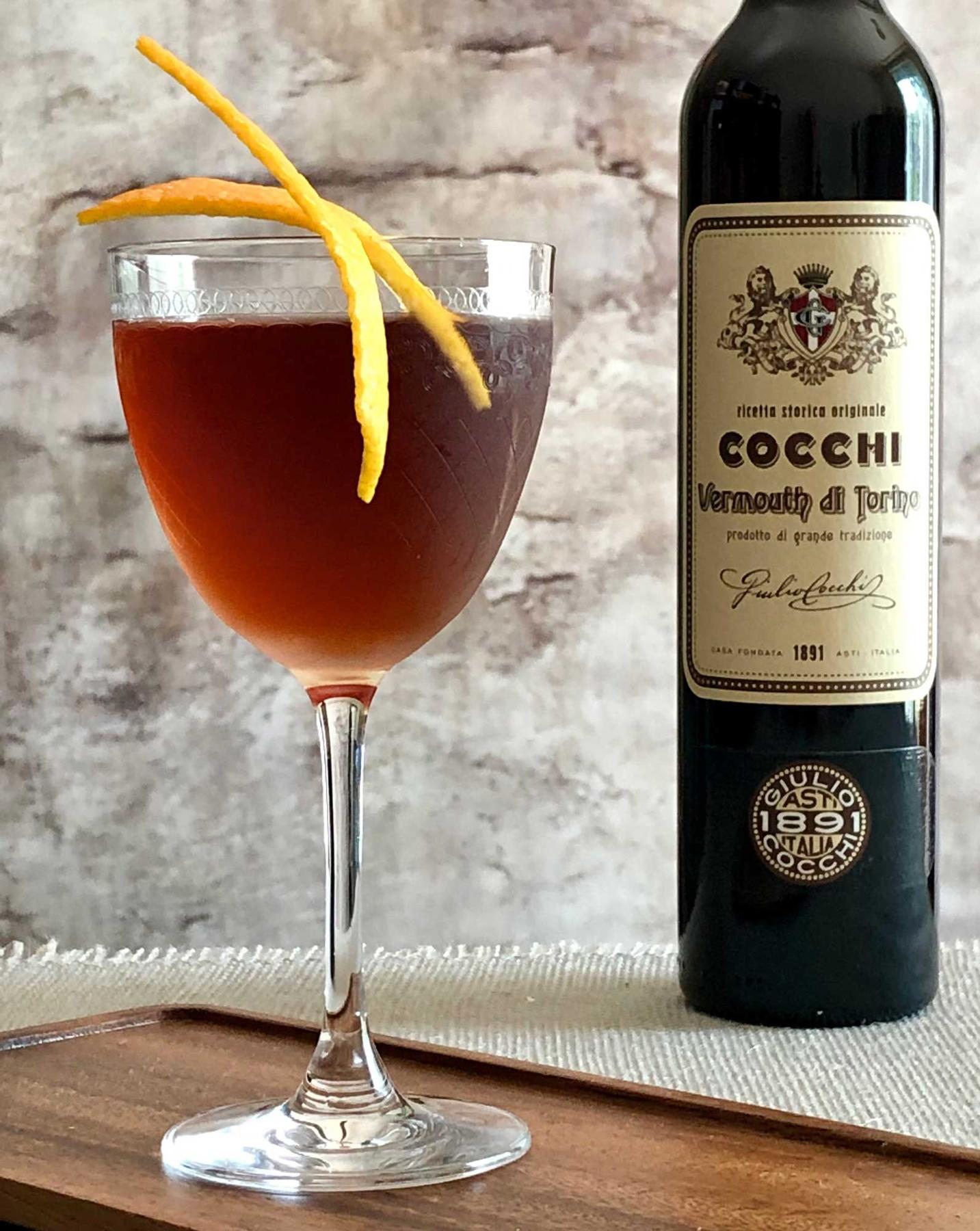 An example of the Martinez de Colón, the mixed drink (drink) featuring mezcal, Cocchi Vermouth di Torino ‘Storico’, maraschino liqueur, Angostura bitters, orange bitters, and orange twist; photo by Lee Edwards