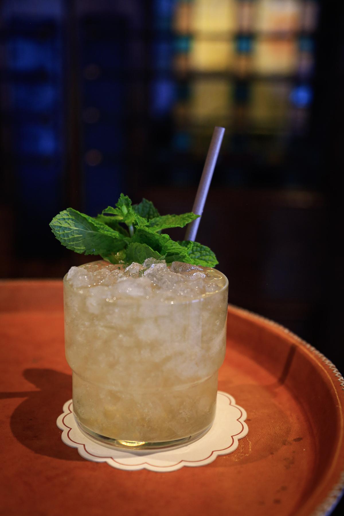 An example of the B-Side, the mixed drink (drink), Adapted from a recipe by Gracy Ramirez, Los Angeles, CA, featuring fino sherry, soda water, Menthe Verte de la Vallée de l’Isère, Hayman’s Old Tom Gin, and lemon juice; photo by Megan Heinowski