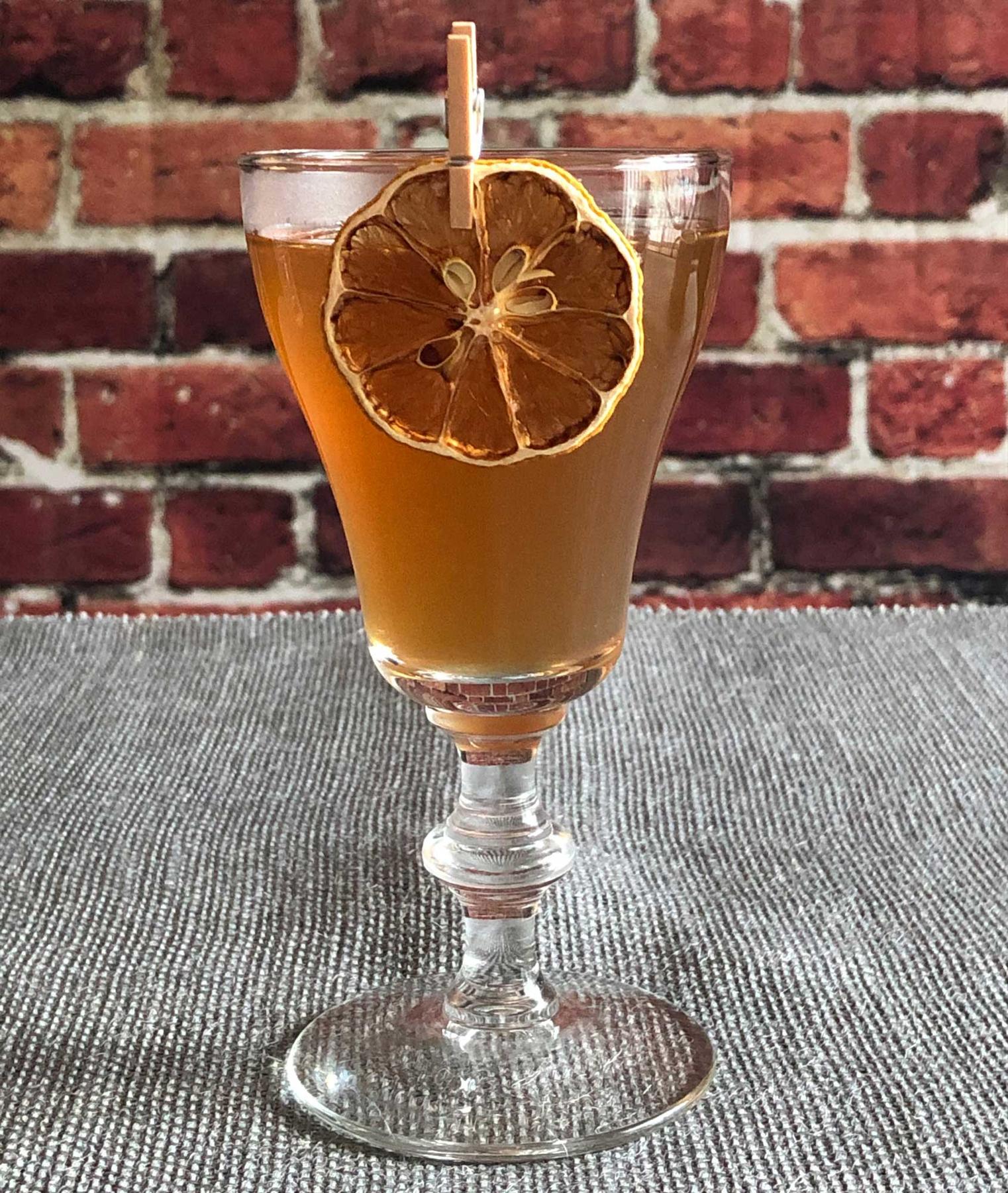 An example of the Bonal Toddy, the mixed drink (drink) featuring hot water, Bonal Gentiane-Quina, rye whiskey, honey syrup, lemon juice, and lemon wheel; photo by Lee Edwards