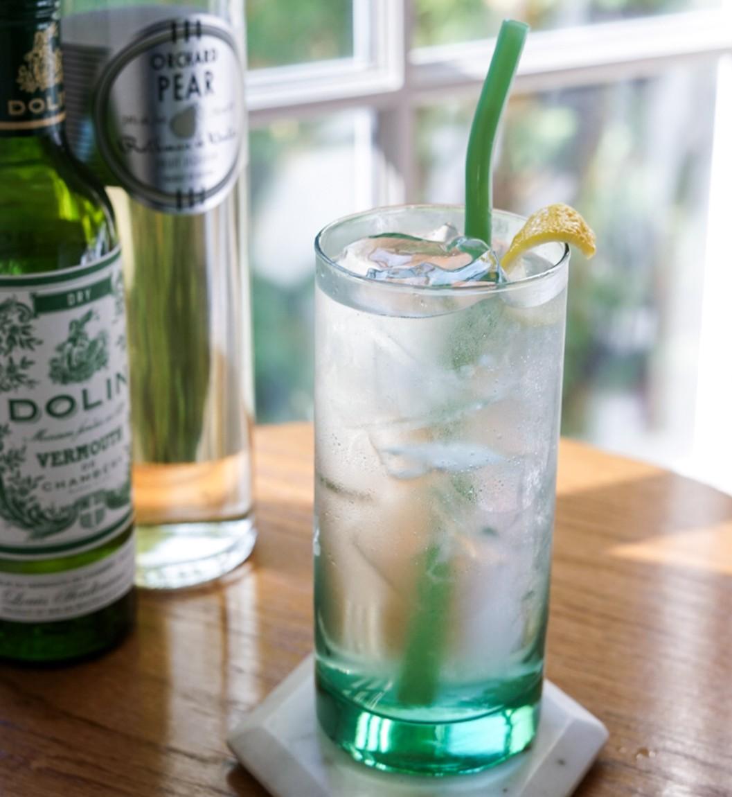 An example of the Pear Falls, the mixed drink (drink) featuring soda water, Rothman & Winter Orchard Pear Liqueur, Dolin Dry Vermouth de Chambéry, and lemon twist; photo by Madison Young