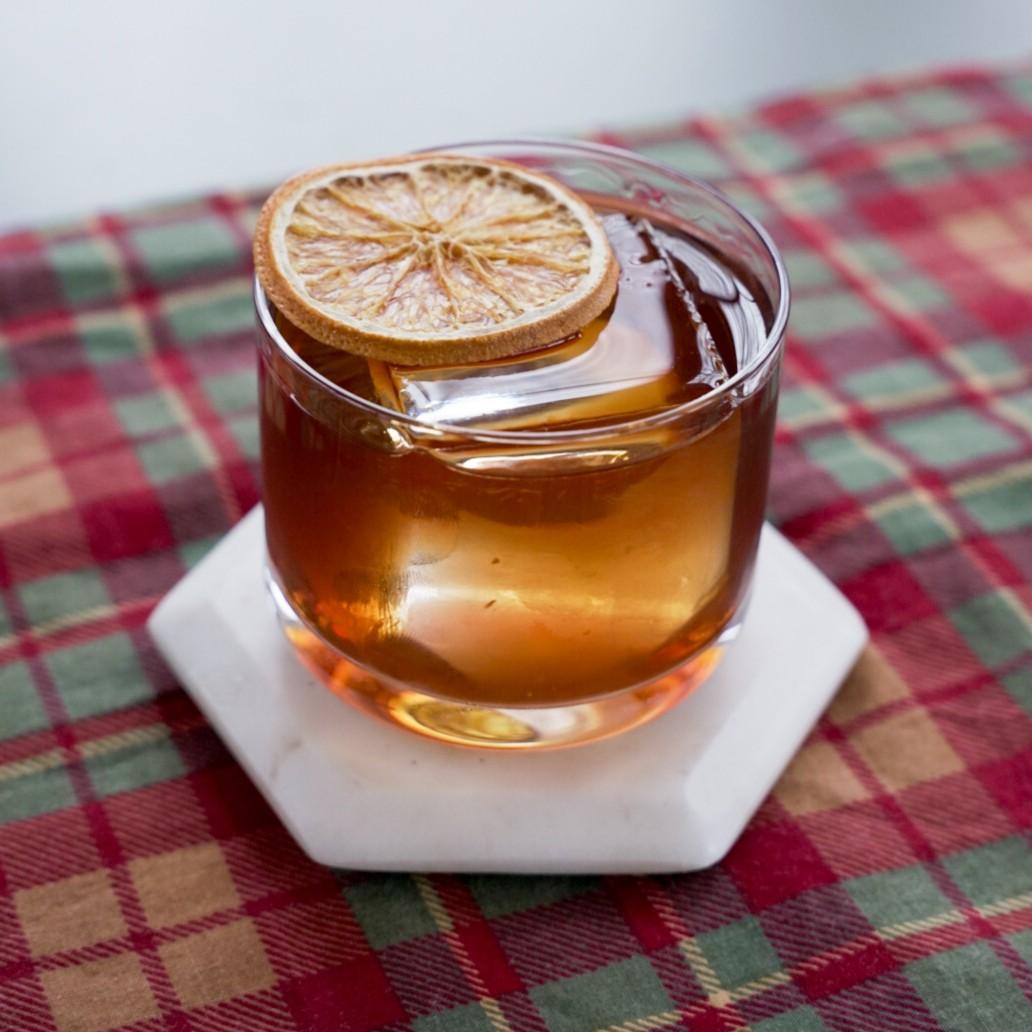 An example of the Walnut Old Fashioned, the mixed drink (drink) featuring bourbon whiskey, Nux Alpina Walnut Liqueur, syrup, orange bitters, and orange; photo by Madison Young