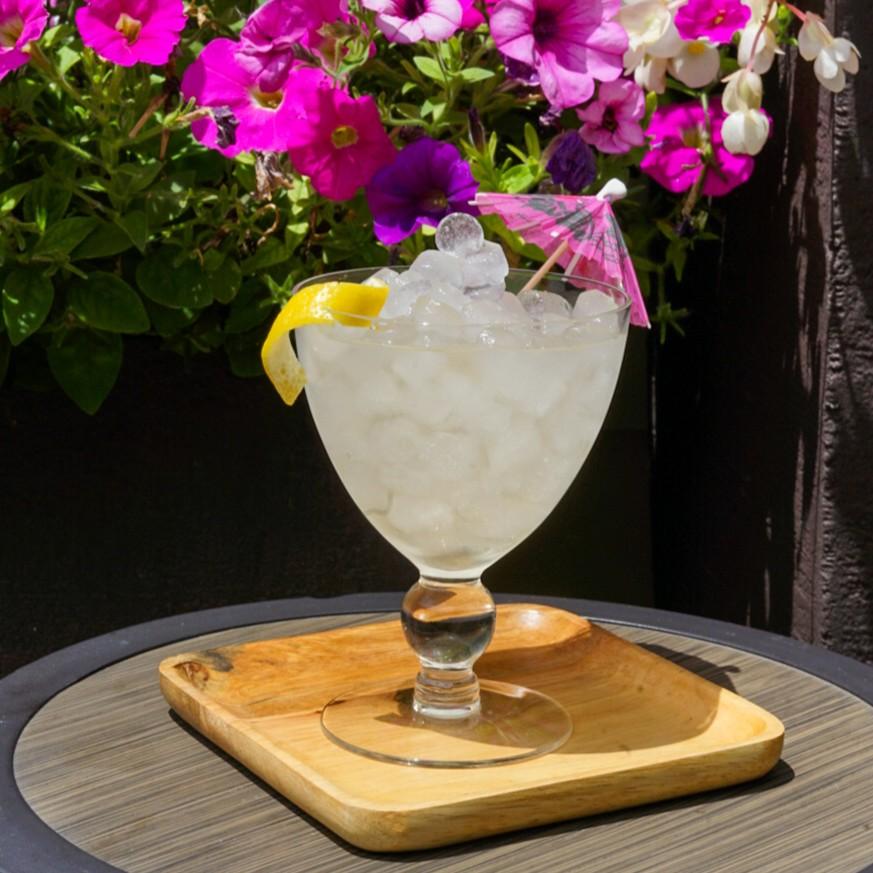 An example of the Pickled Peach Cooler, the mixed drink (drink) featuring soda water, Timbal Vermut de Reus Extra Dry, Rothman & Winter Orchard Peach Liqueur, and lemon twist