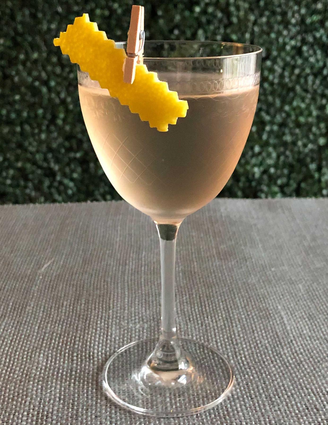 An example of the Alpine Martini, the mixed drink (drink) featuring Hayman’s London Dry Gin, Dolin Dry Vermouth de Chambéry, Zirbenz Stone Pine Liqueur of the Alps, and lemon twist; photo by Lee Edwards