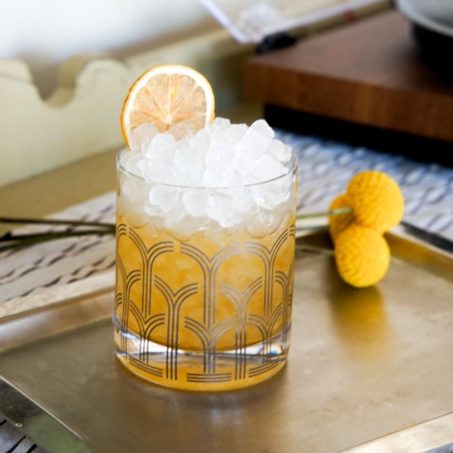 An example of the Royal Garden Tea, the mixed drink (drink) featuring green tea, Rothman & Winter Orchard Quince Liqueur, and lemon twist