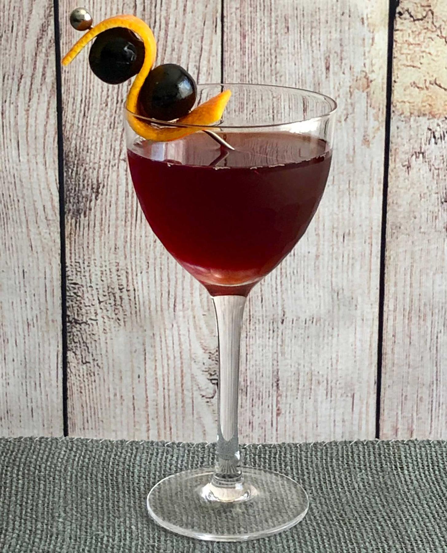 An example of the Booker’s Manhattan, the mixed drink (drink), by T. Leggett, The Roosevelt, Richmond, VA, featuring Booker’s Bourbon, Cocchi Barolo Chinato, Angostura bitters, orange twist, and maraschino cherry; photo by Lee Edwards