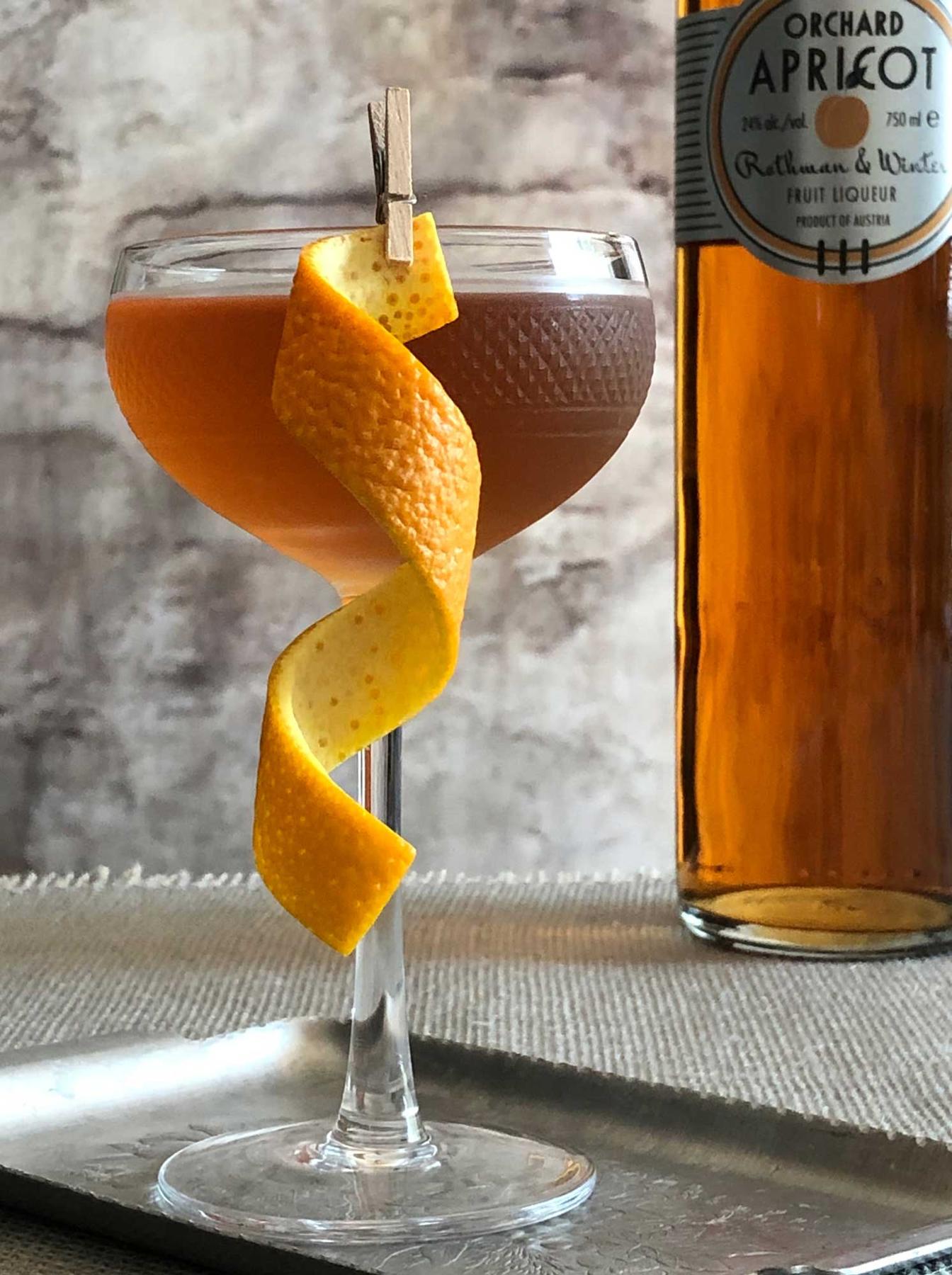 An example of the Angel Face, the mixed drink (drink), by Savoy Cocktail Book, featuring Hayman’s London Dry Gin, calvados, Rothman & Winter Orchard Apricot Liqueur, and orange twist; photo by Lee Edwards