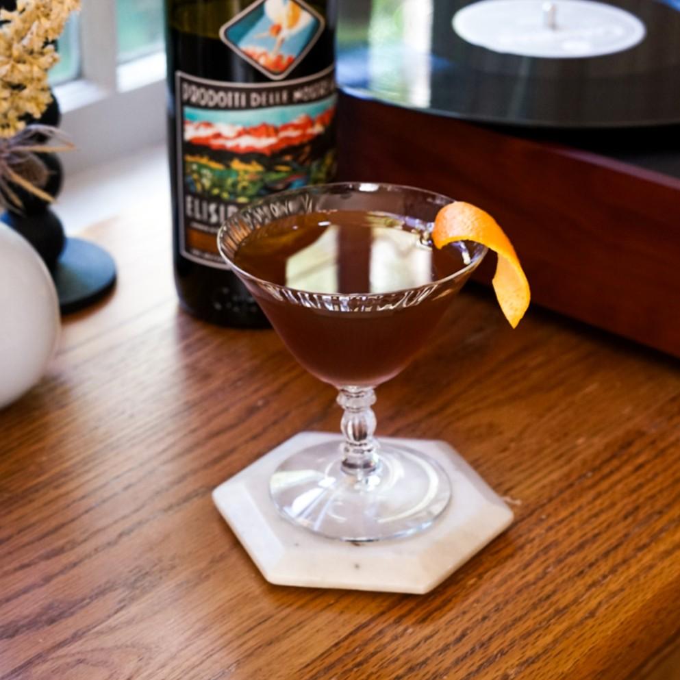 An example of the Toronto Adjacent, the mixed drink (drink) featuring rye whiskey, Elisir Novasalus, simple syrup, Angostura bitters, and orange twist; photo by Madison Young