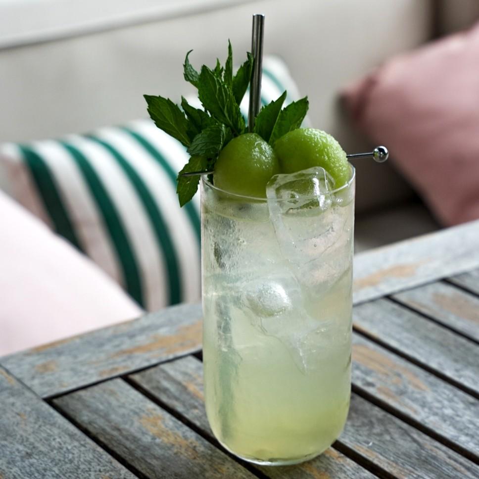 An example of the Ace’s Motive, the mixed drink (drink) featuring soda water, vodka, Menthe Verte Spearmint Liqueur, lemon juice, and honeydew melon; photo by Madison Young