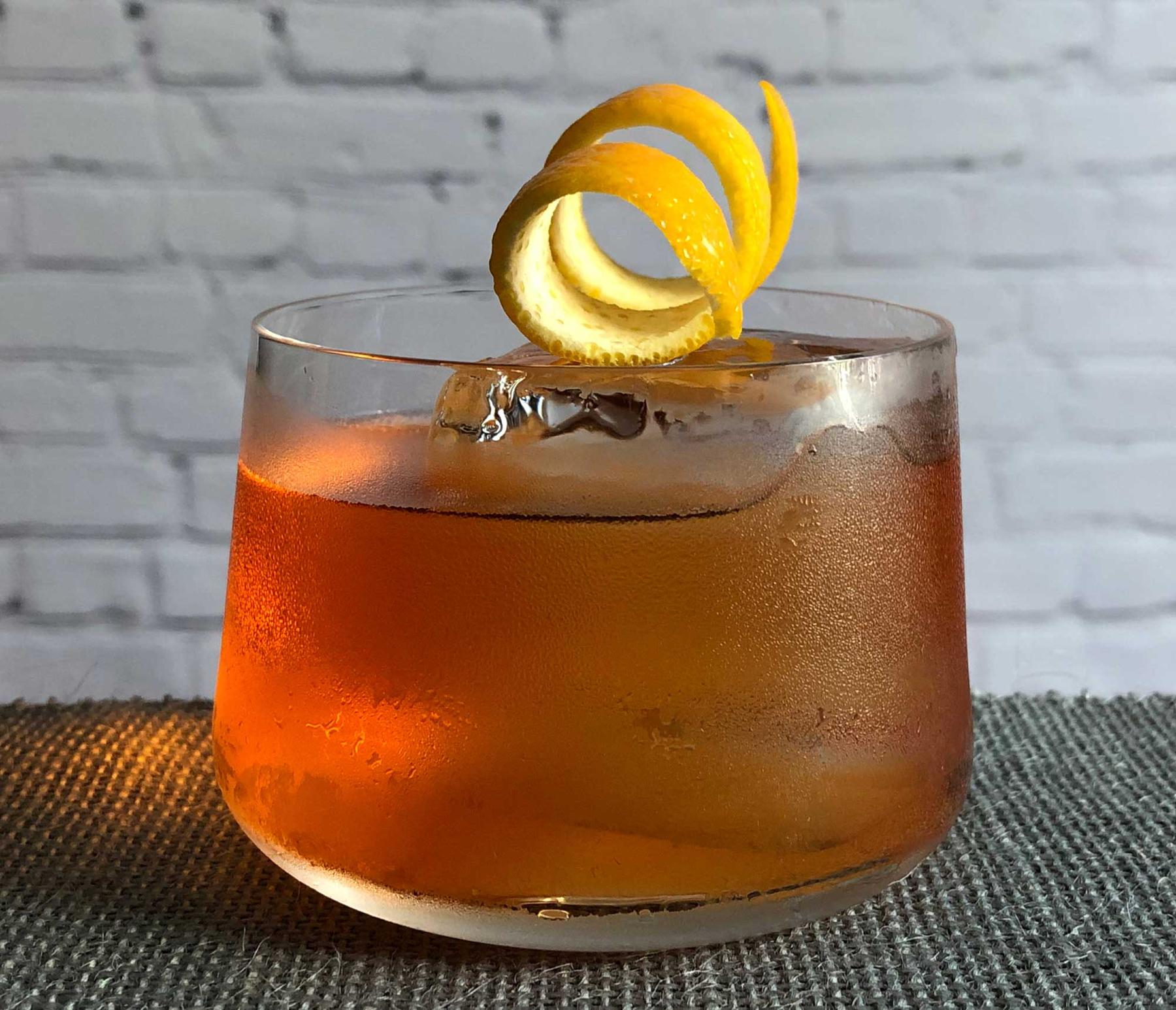 An example of the Old Pal, the mixed drink (drink) featuring bourbon whiskey, Aperitivo Cappelletti, Cocchi Vermouth di Torino Extra Dry, and orange twist; photo by Lee Edwards