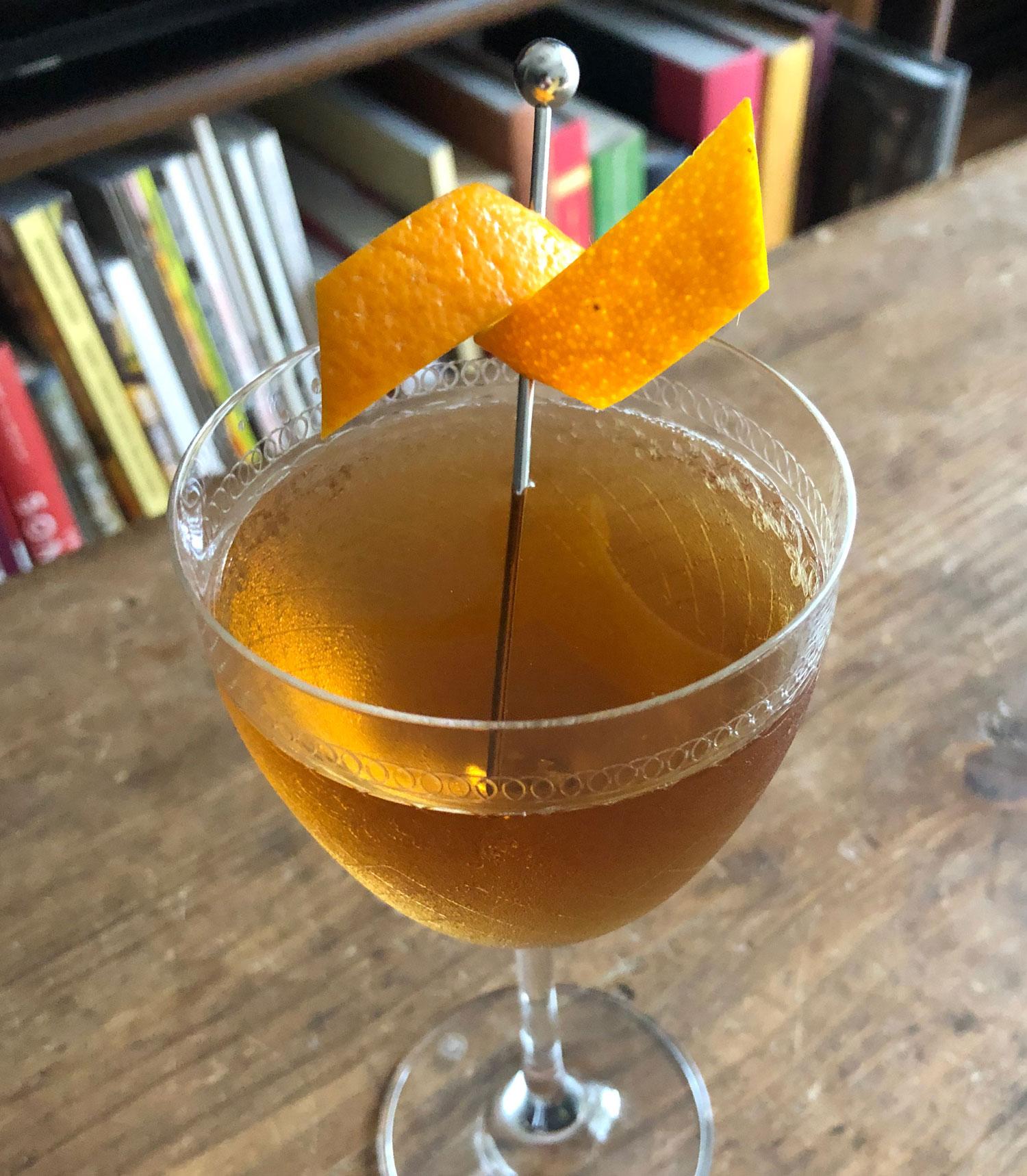 An example of the Bobby Burns, the mixed drink (drink) featuring scotch whisky, Dolin Rouge Vermouth de Chambéry, Bénédictine, and orange twist; photo by Lee Edwards