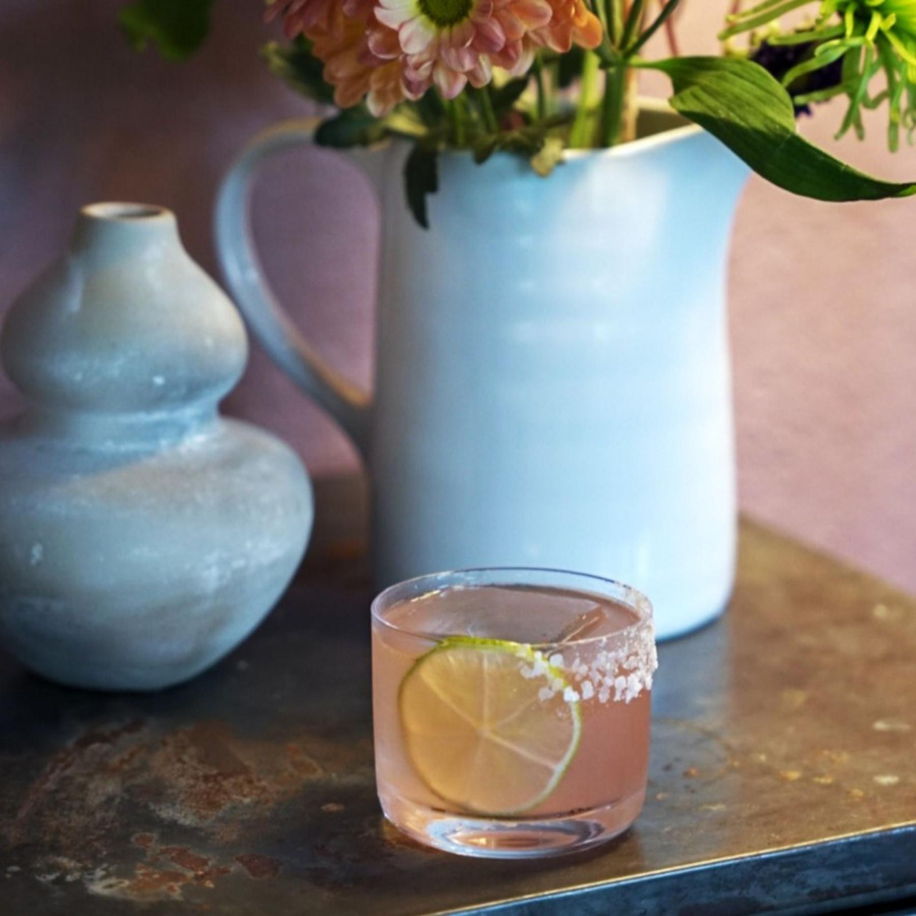 An example of the Menthe Fraîche, the mixed drink (drink) featuring watermelon juice, blanco tequila, Menthe Verte Spearmint Liqueur, lime juice, and lime wheel; photo by Madison Young