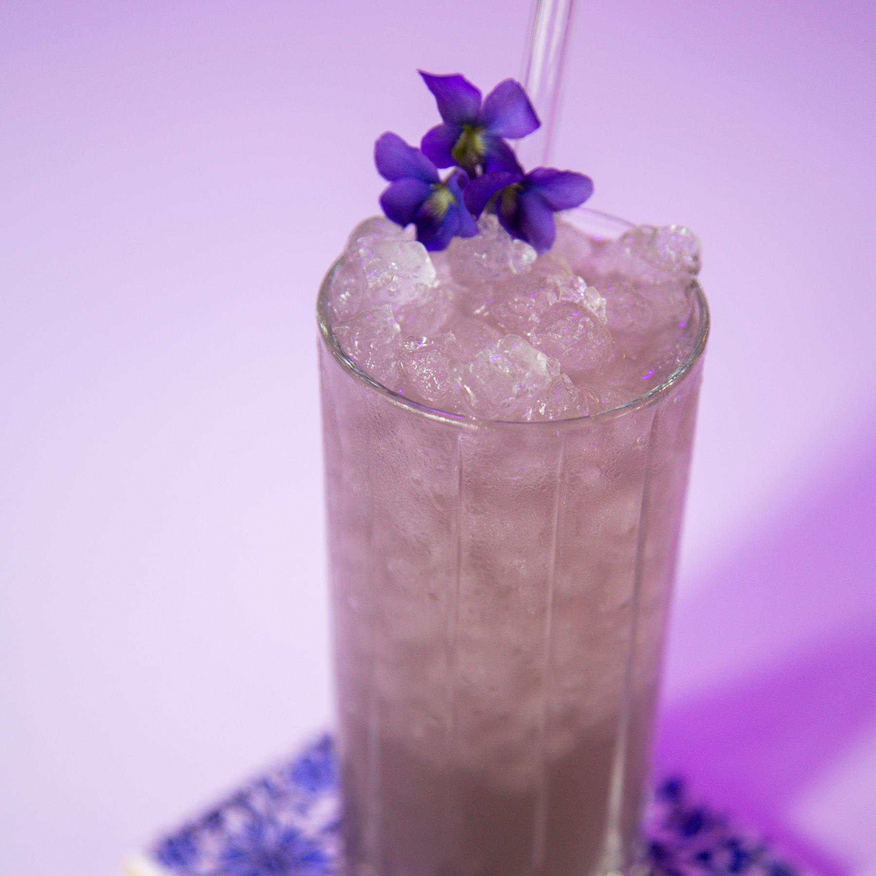 An example of the Violette Lemonade, the mixed drink (drink) featuring lemonade, Rothman & Winter Crème de Violette, and lemon twist