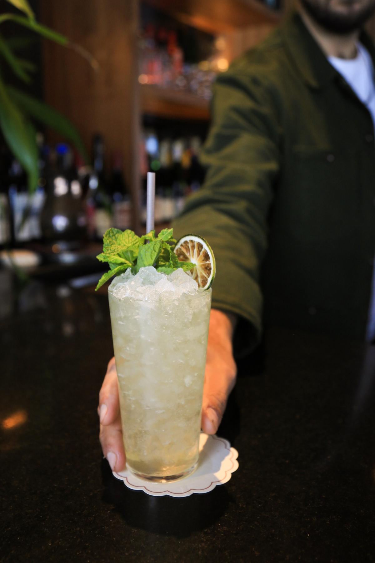 An example of the Mojito, the mixed drink (drink) featuring soda water, light rum, Menthe Verte de la Vallée de l’Isère, lime juice, and soda water; photo by Megan Heinowski