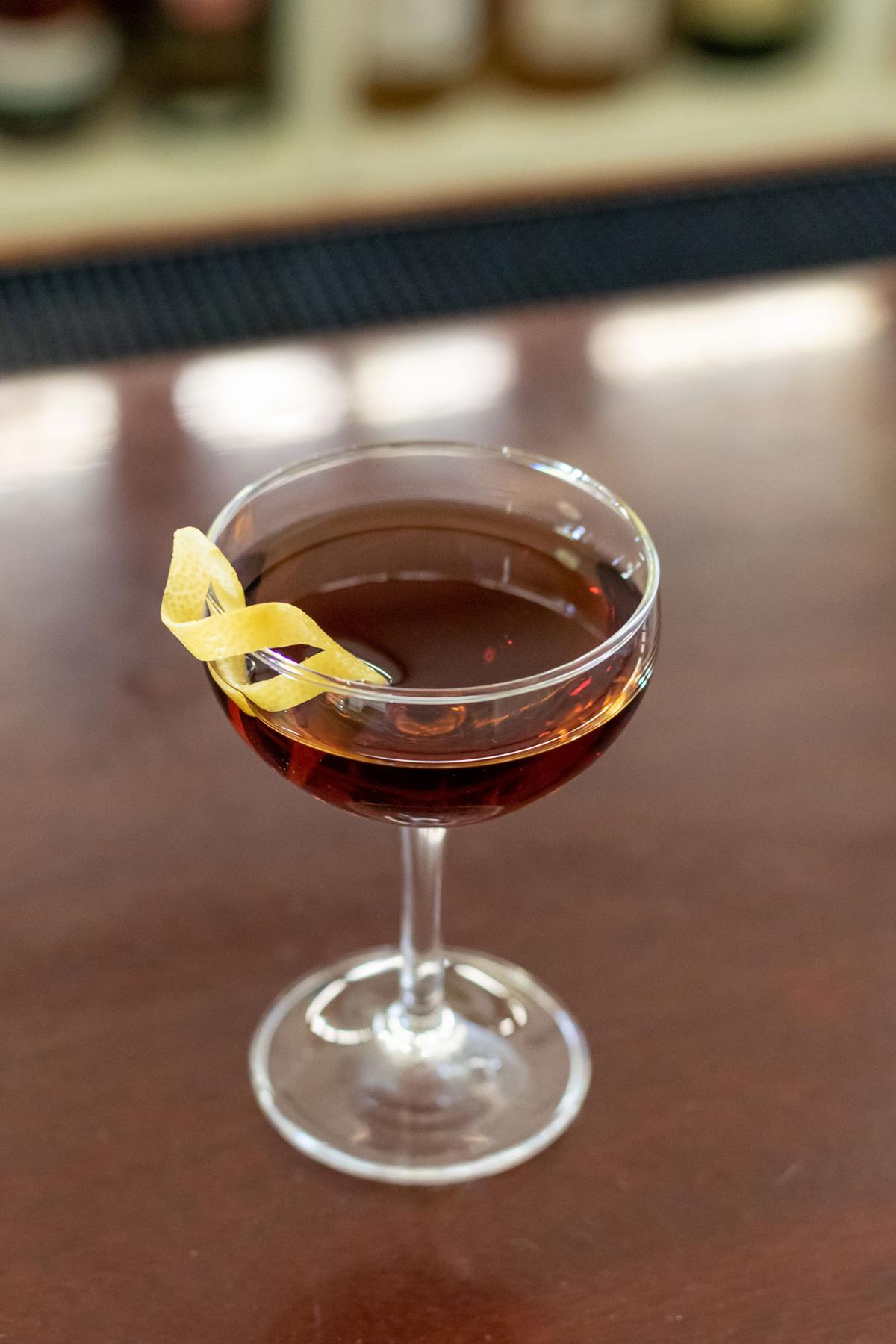 An example of the Coronation, the mixed drink (drink), by Waldorf-Astoria Bar Book, featuring apple brandy, Dolin Dry Vermouth de Chambéry, Timbal Vermut de Reus Sweet Red, apricot eau de vie, and lemon twist; photo by Boon and Caro Sheridan