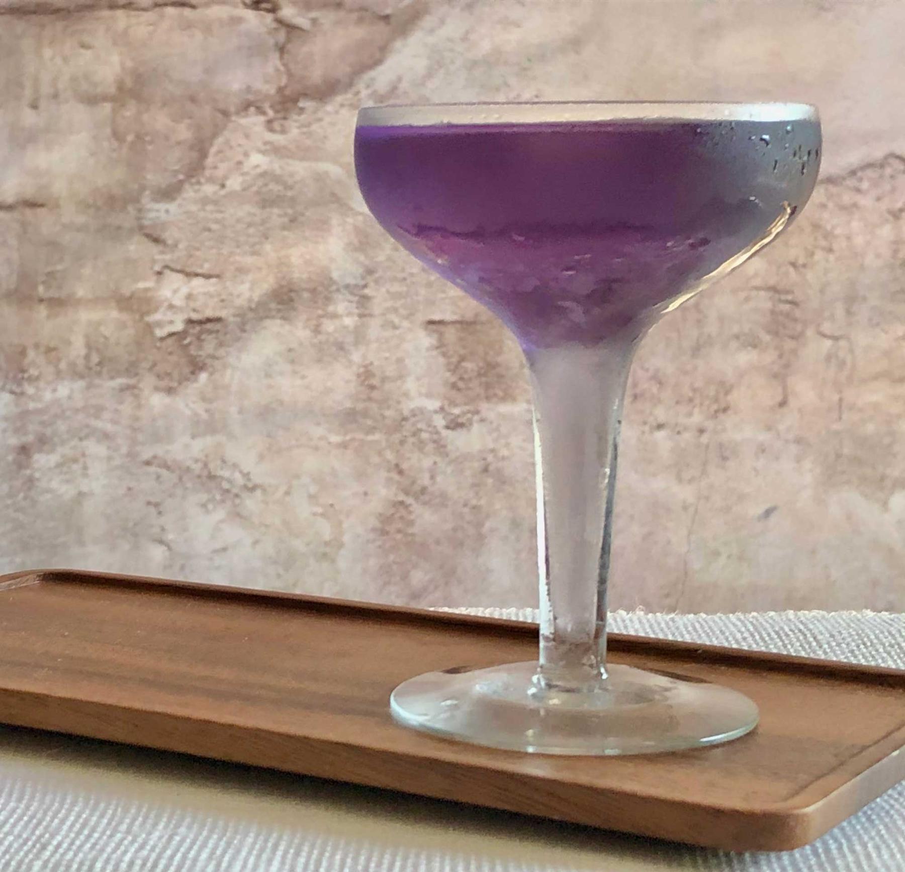 An example of the Night Flights, the mixed drink (drink), by Andra Johnson, Washington D.C., featuring Hayman’s London Dry Gin, vodka, Salers Gentian Apéritif, Rothman & Winter Crème de Violette, lemon twist, and maraschino cherry; photo by Lee Edwards