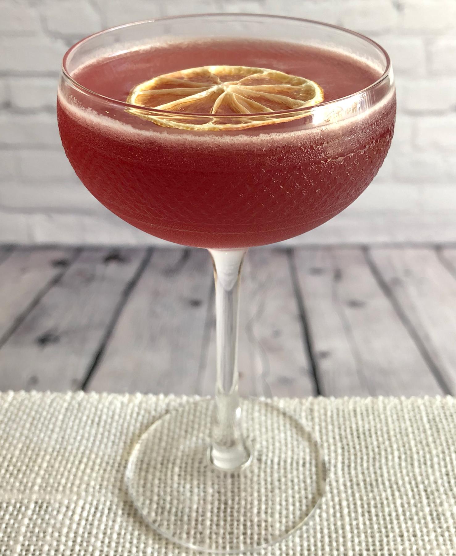An example of the Scofflaw, the mixed drink (drink) featuring rye whiskey, Cocchi Vermouth di Torino Extra Dry, lemon juice, grenadine, and lemon twist; photo by Lee Edwards