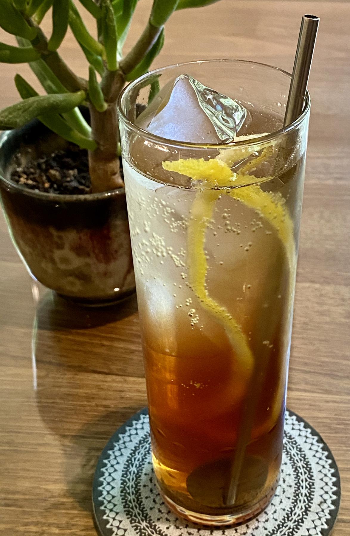 An example of the Berry to Ferry, the mixed drink (drink) featuring seltzer, Pasubio Vino Amaro, Mattei Cap Corse Blanc Quinquina, and lemon twist; photo by Martin Doudoroff