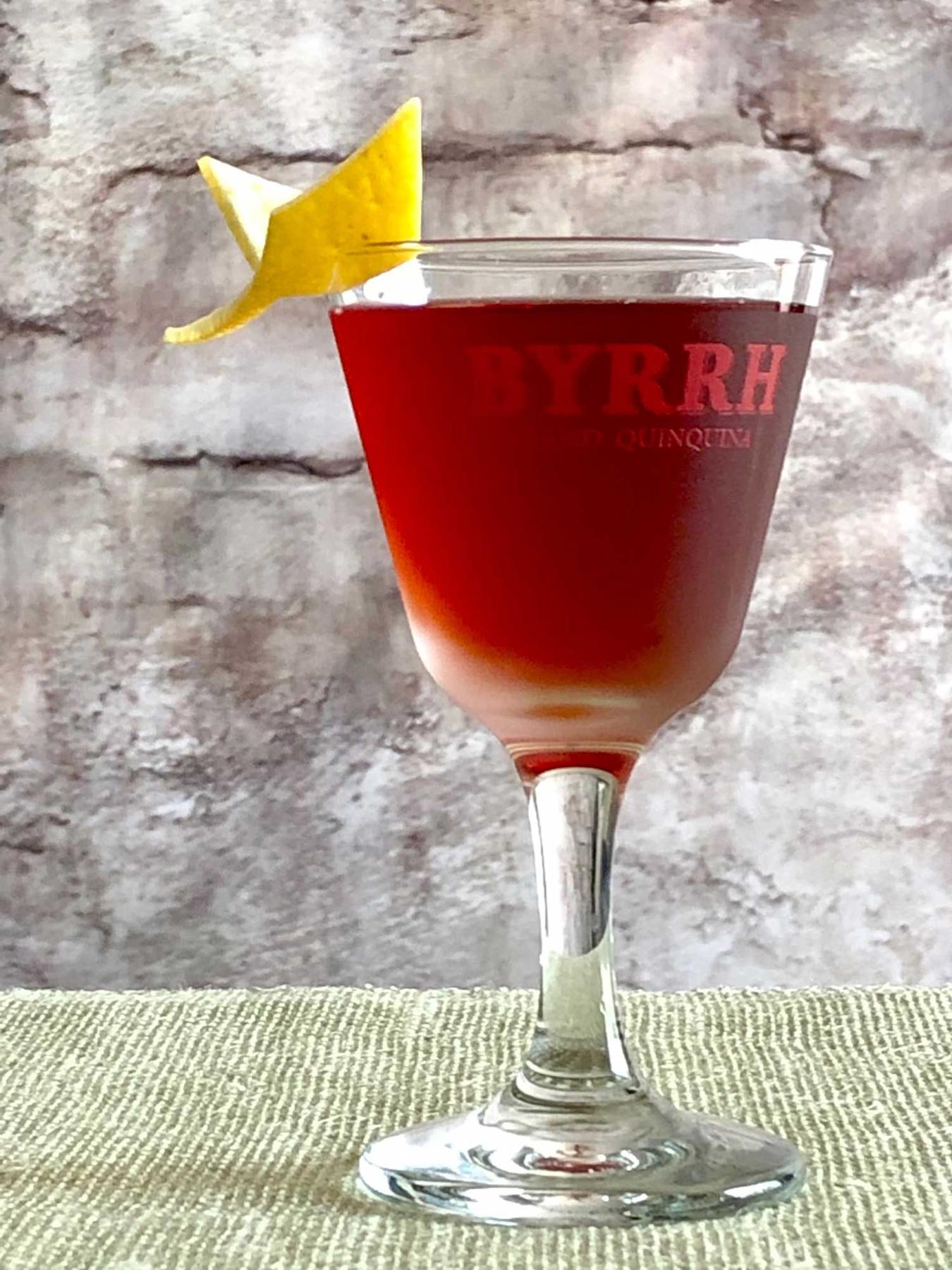 An example of the Betsy Ross, the mixed drink (drink), by David Embury, The Fine Art of Mixing Drinks, featuring grape brandy, Byrrh Grand Quinquina, curaçao, Angostura bitters, and lemon twist; photo by Lee Edwards
