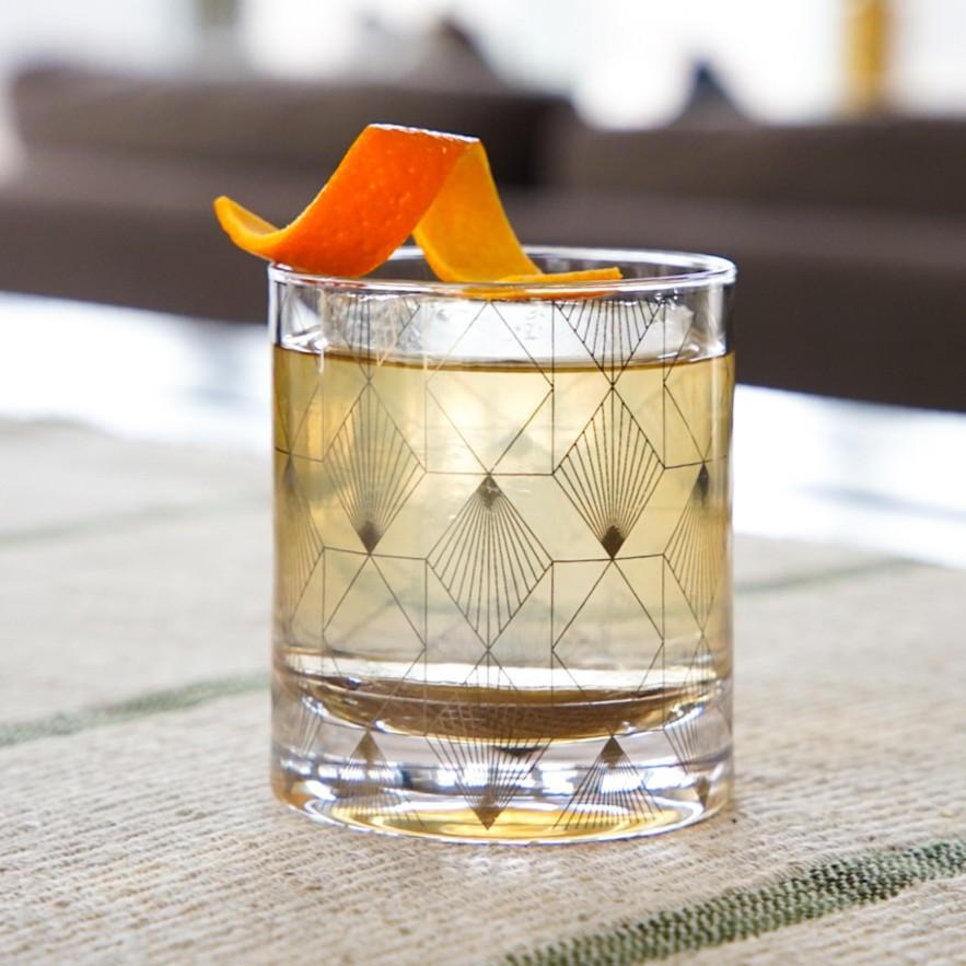 An example of the Quince of Fashion, the mixed drink (drink) featuring Etter Quince, rye whiskey, Bonal Gentiane-Quina, honey syrup, cinnamon-infused sugar syrup, orange bitters, and orange twist
