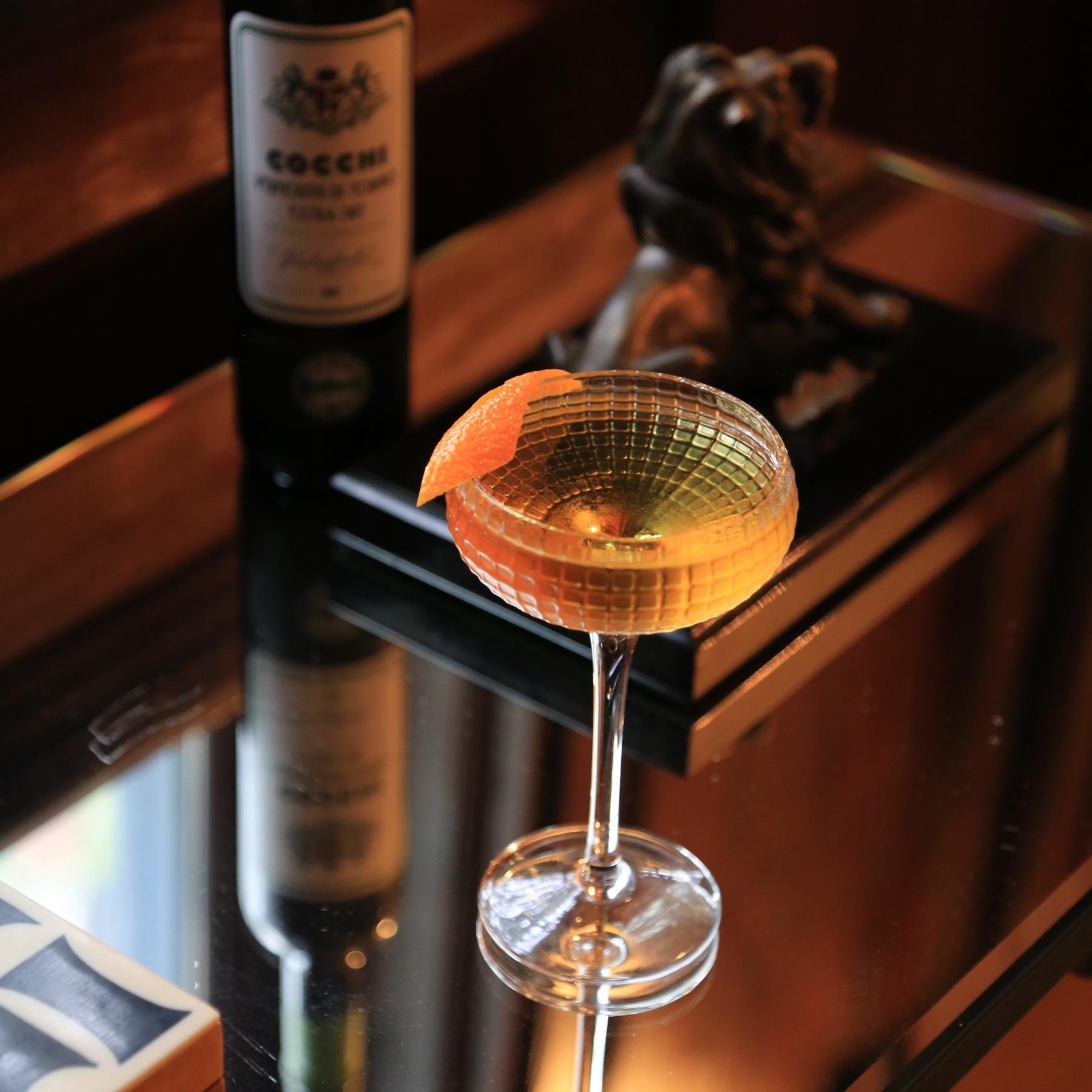 An example of the Brainstorm, the mixed drink (drink) featuring irish whiskey, Cocchi Vermouth di Torino Extra Dry, Bénédictine, and orange twist; photo by Megan Heinowski