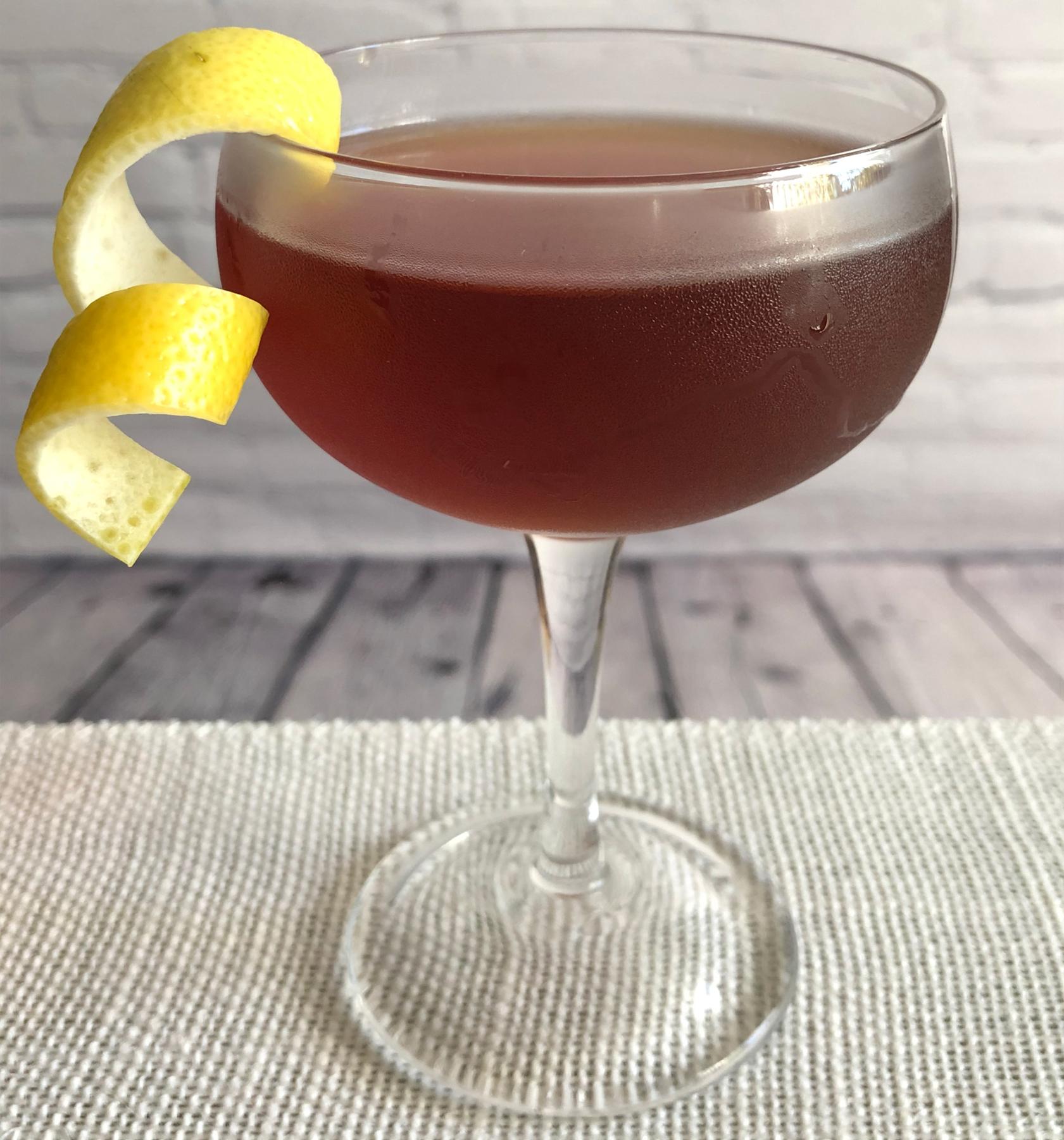 An example of the Transatlantic Giant, the mixed drink (drink), by Colin Shearn, Franklin Mortgage & Investment Company, Philadelphia, featuring bourbon whiskey, Smith & Cross Traditional Jamaica Rum, Cynar, Hayman’s Sloe Gin, crème de cacao (white), Angostura bitters, and lemon twist; photo by Lee Edwards