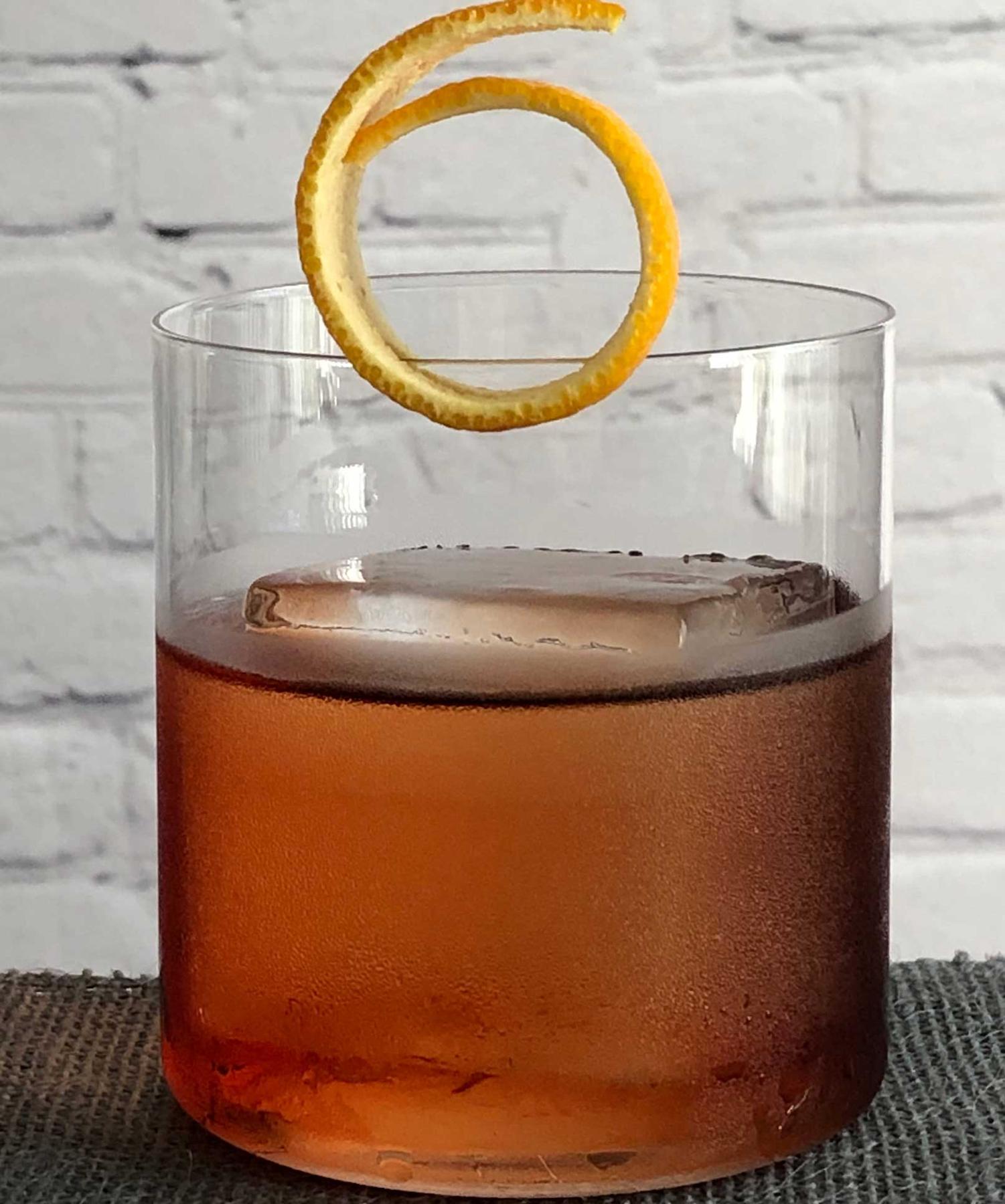 An example of the Crosstown Traffic, the mixed drink (drink) featuring Hayman’s London Dry Gin, Cardamaro Vino Amaro, Cocchi Americano Rosa, and orange twist; photo by Lee Edwards