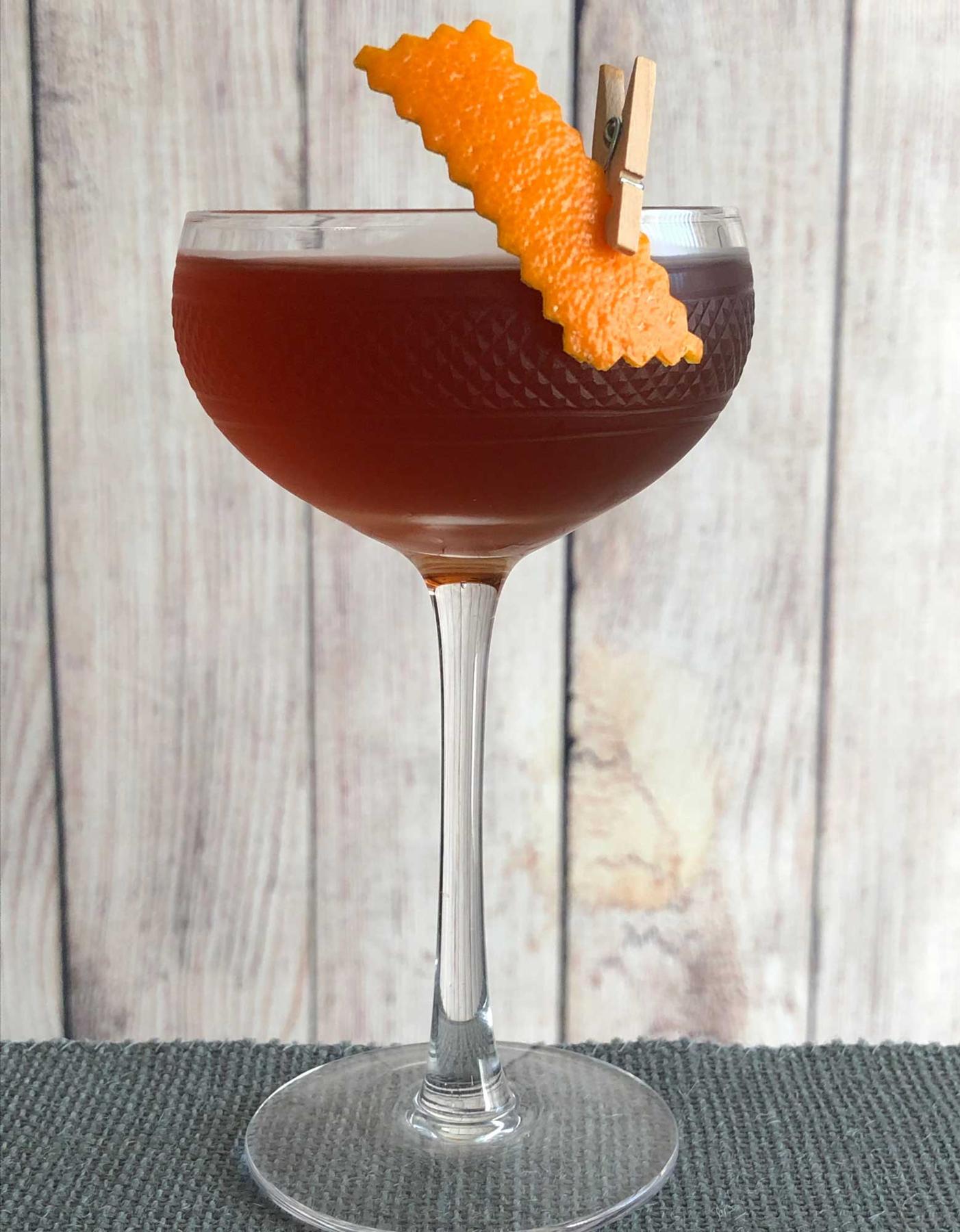 An example of the Palmetto No. 2, the mixed drink (drink) featuring The Scarlet Ibis Trinidad Rum, Dolin Rouge Vermouth de Chambéry, orange bitters, Angostura bitters, and orange twist; photo by Lee Edwards