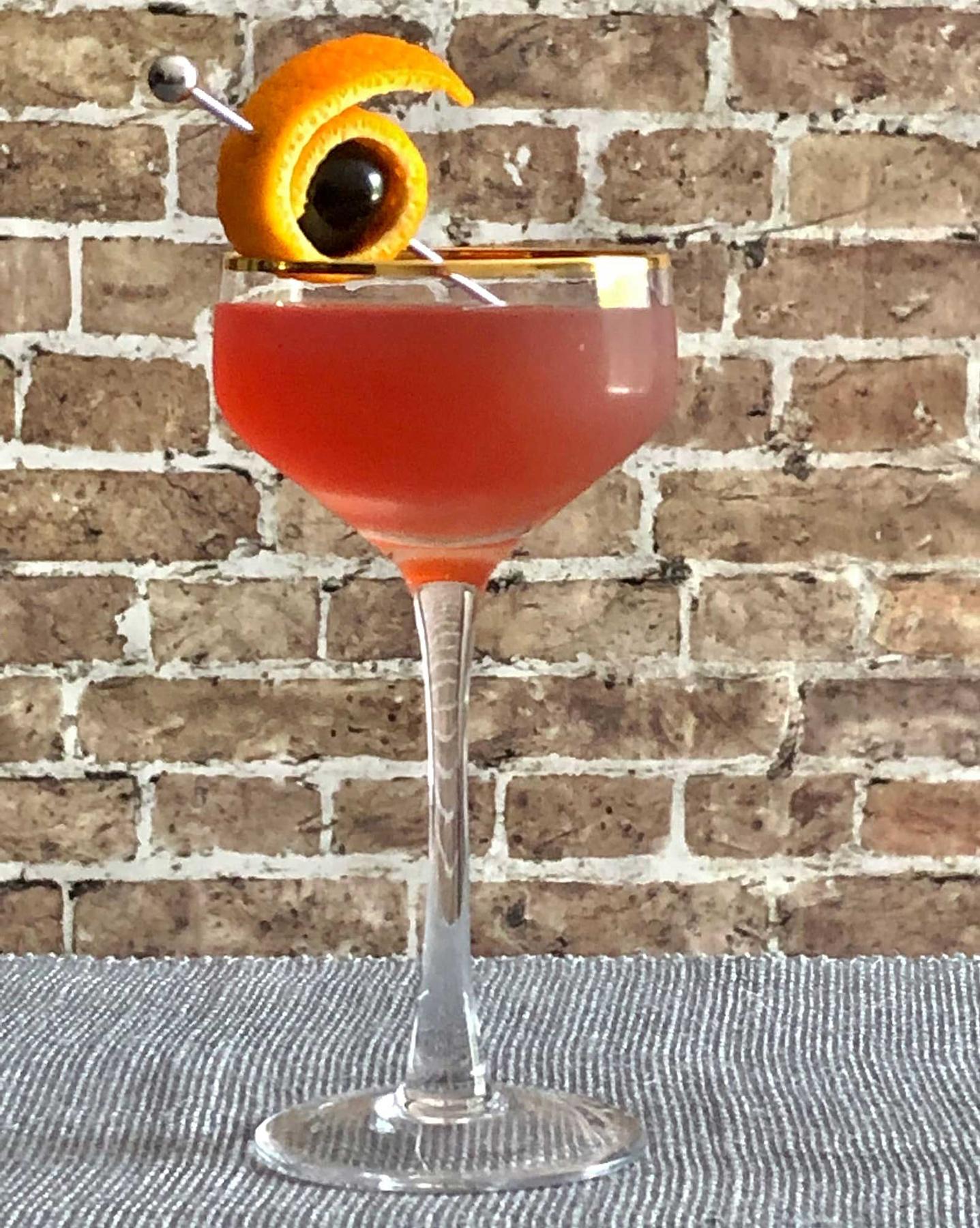 An example of the Bitches’ Brew, the mixed drink (drink), by Simon Difford, featuring Byrrh Grand Quinquina, genever, vodka, india pale ale, orange twist, and maraschino cherry; photo by Lee Edwards